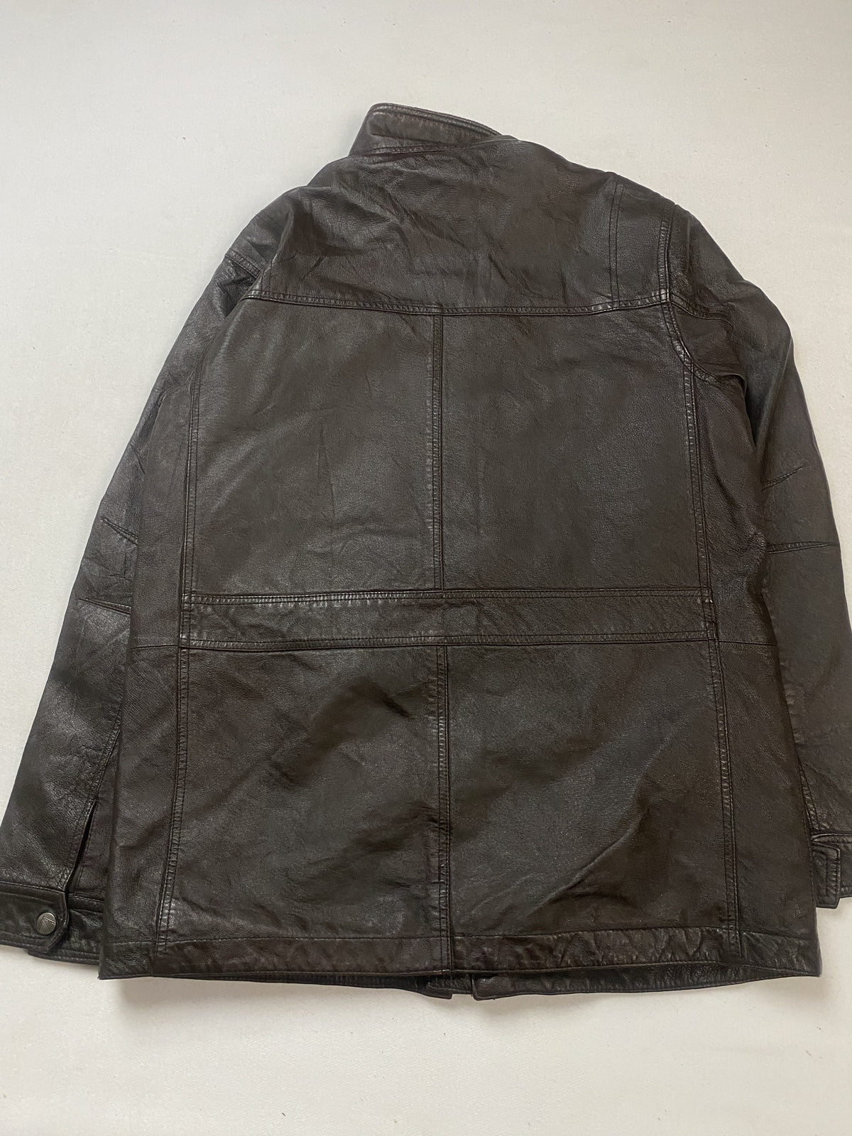 Metal clasp fastening on the brown leather field jacket