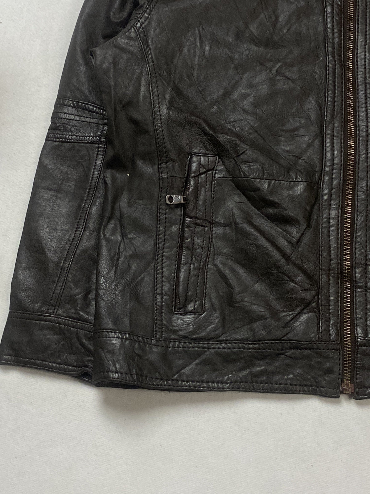 Blue lining inside the brown leather harrington