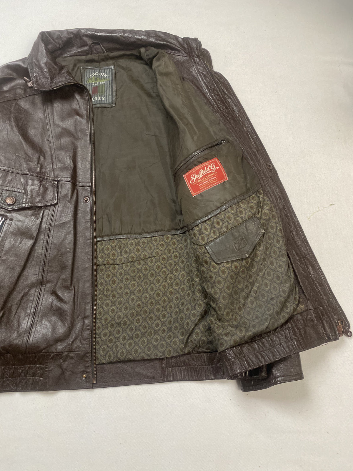 Brown real leather trucker jacket with a 23 inch sleeve, size XL