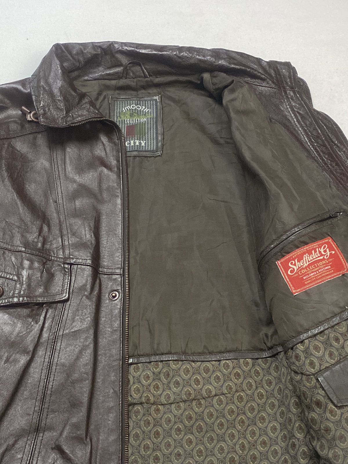 Boxy brown leather trucker jacket in size XL with a 19 inch shoulder
