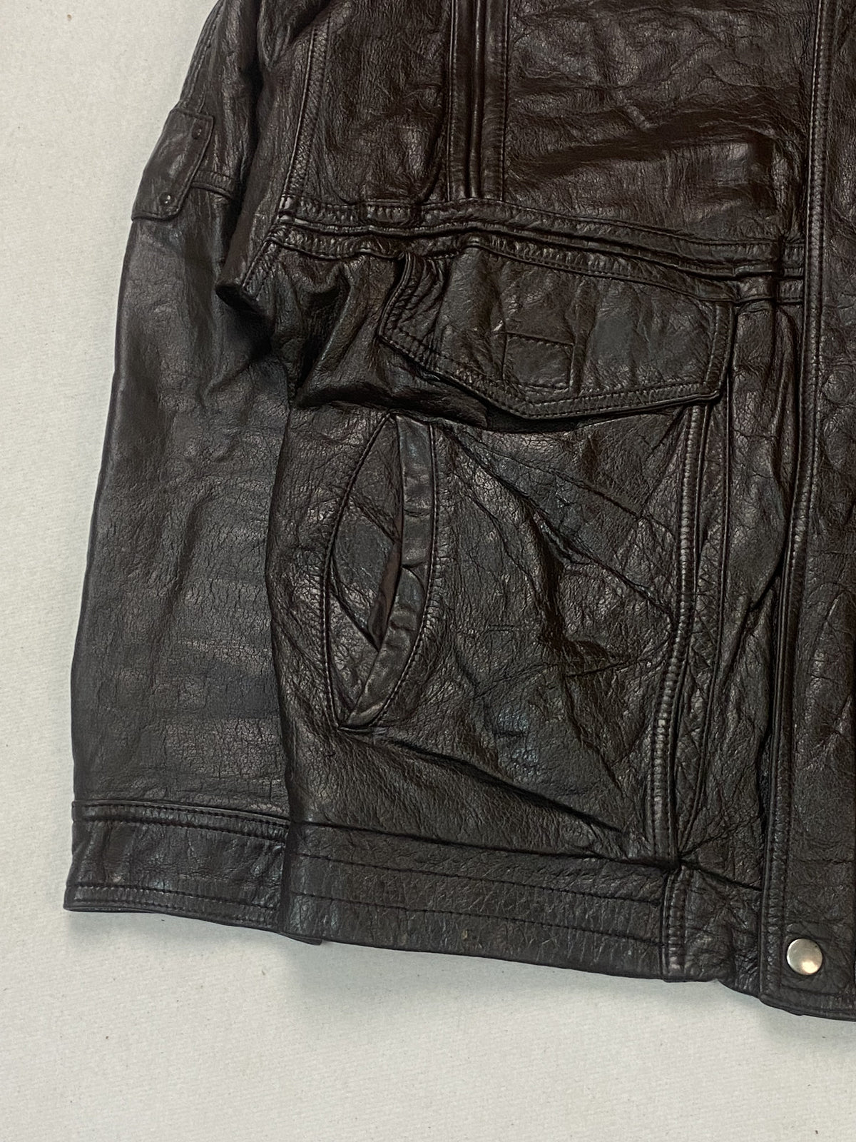 Detail of a flap pocket with the slanted hand opening set beneath it