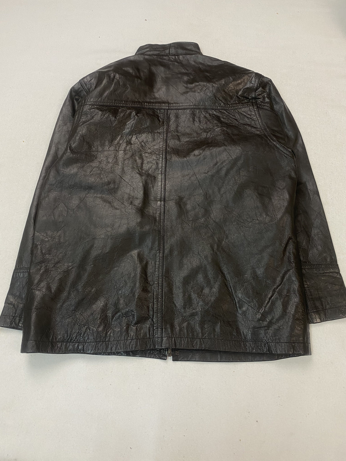Triple stitching around a pocket on the brown leather jacket