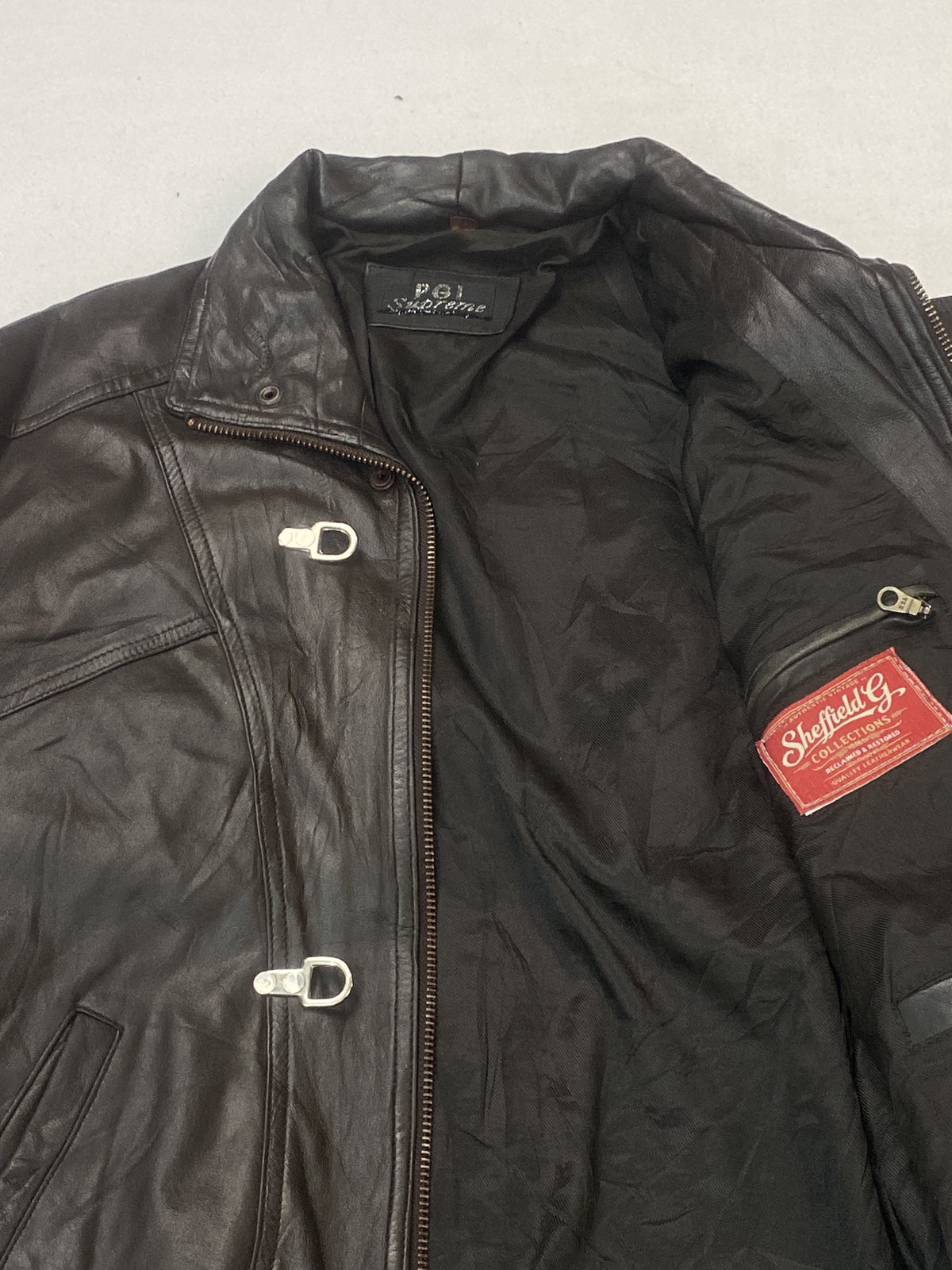 Close view of the collar, toggle clasp and interior pocket at the top of the jacket