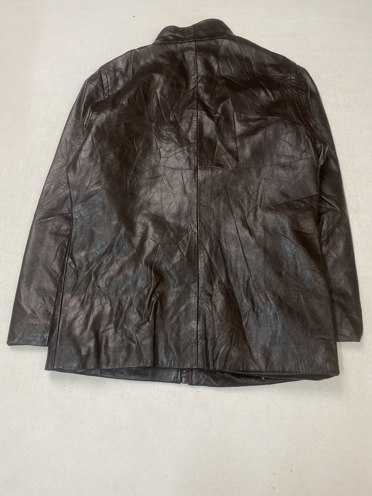Flap pocket on the front of the brown leather trucker jacket