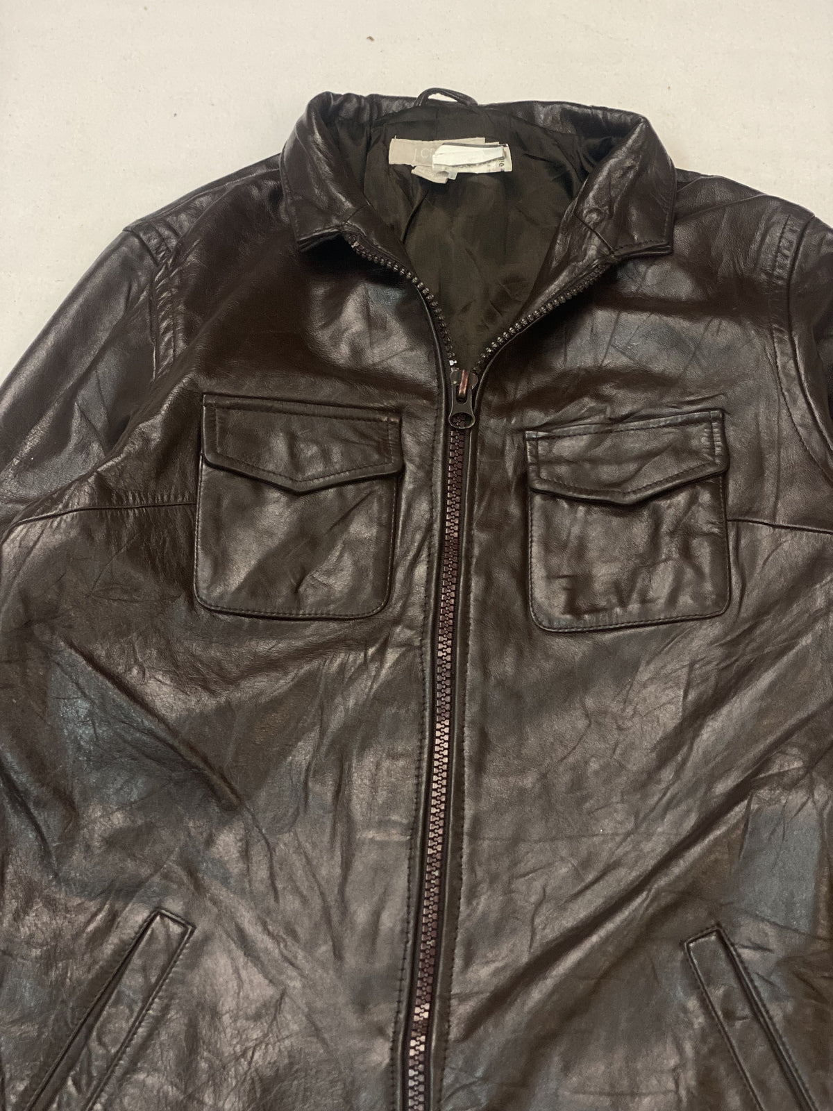 The size XL brown trucker, 27 inches long through the body