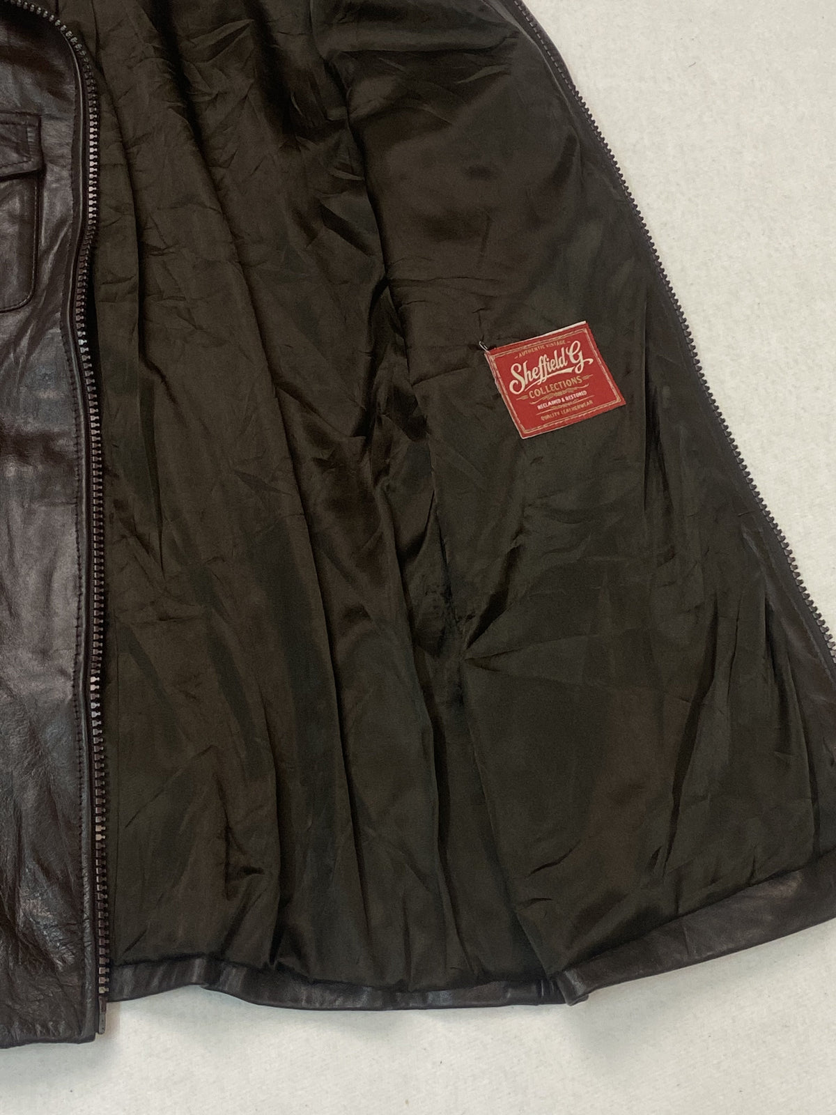 Brown real leather trucker jacket with a 22 inch sleeve, size XL