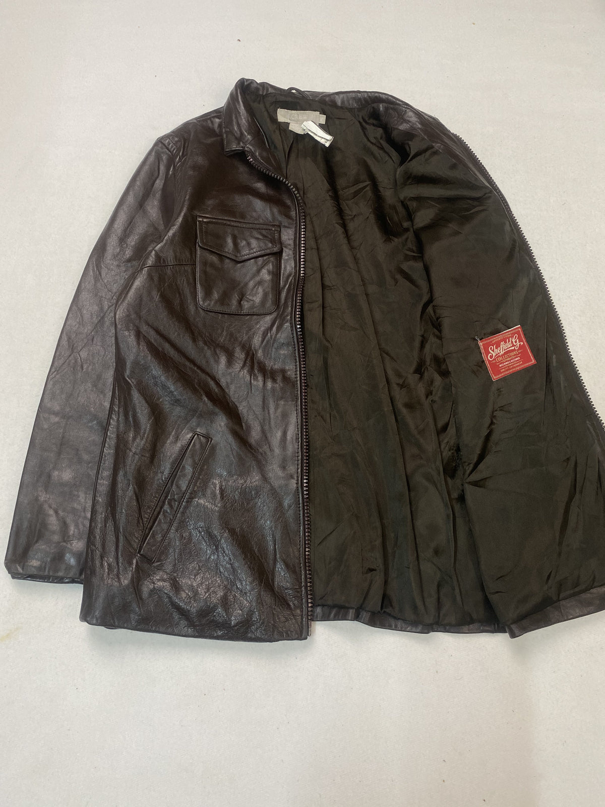 Twin flap pockets set on this brown leather trucker in size XL