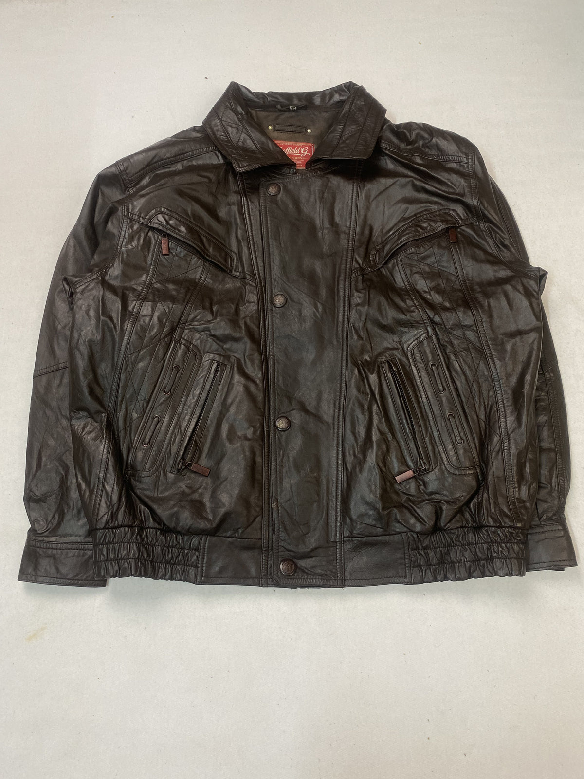 Padded olive lining inside the brown leather harrington