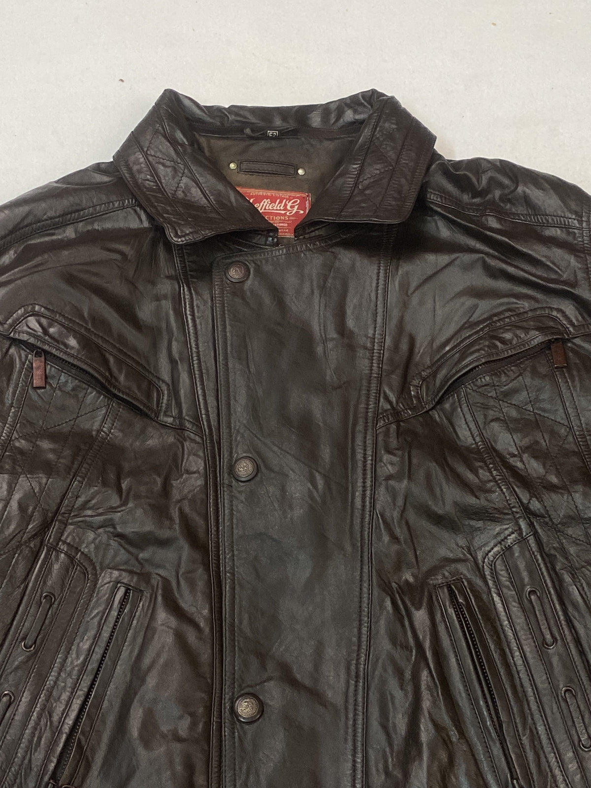 The size XL brown harrington, 28 inches long through the body