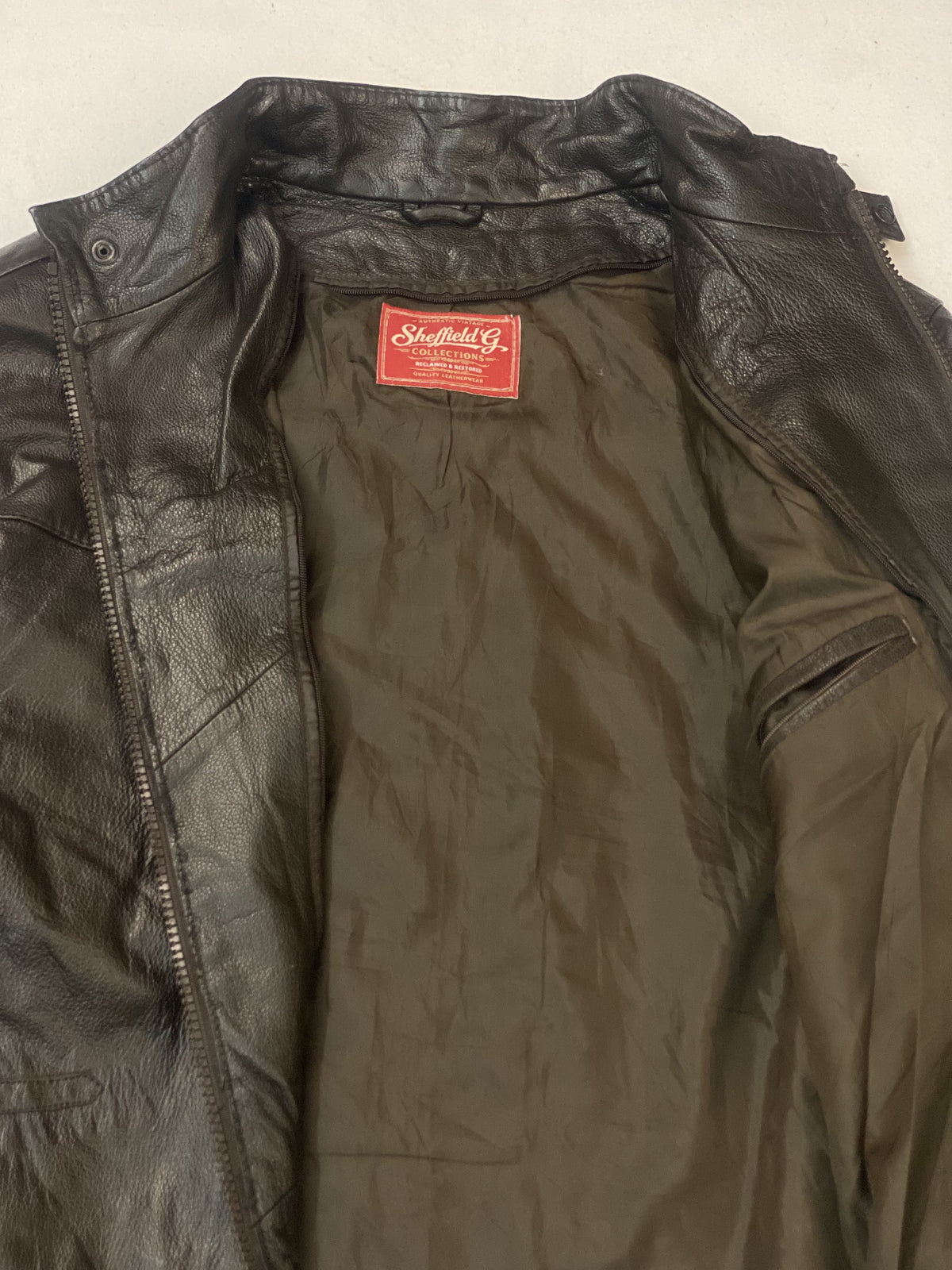The cafe racer opened out to show its full olive green lining