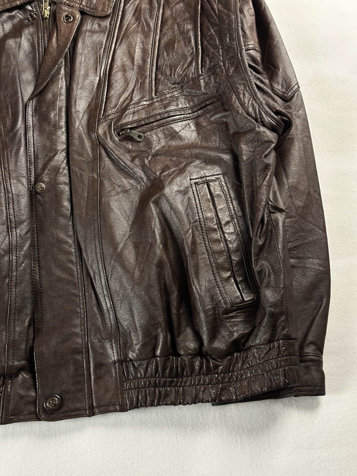 Right side welt pocket beside the stud placket, with the gathered hem below