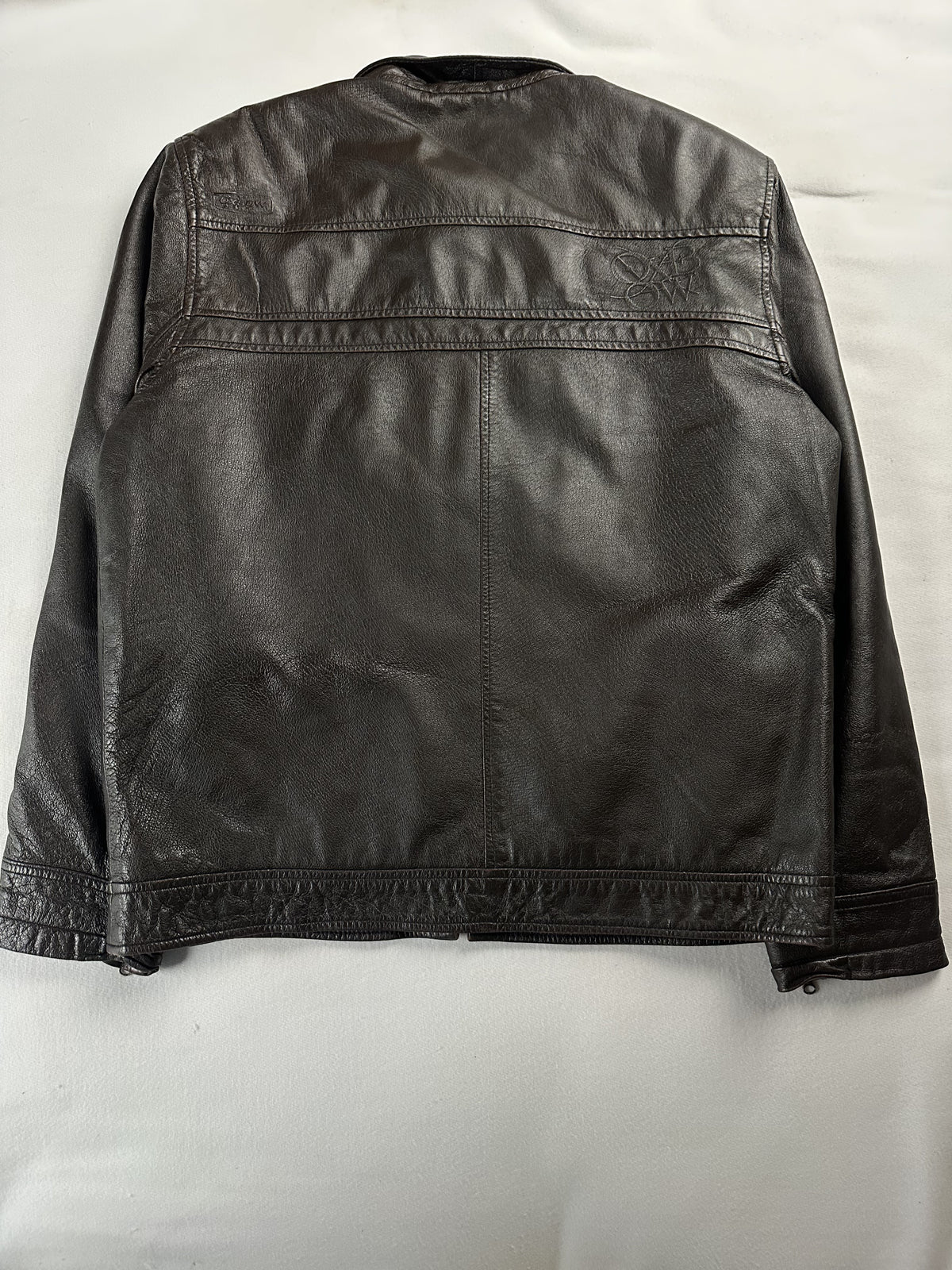 Rear of the L brown jacket showing the shoulder yoke seam and banded hem