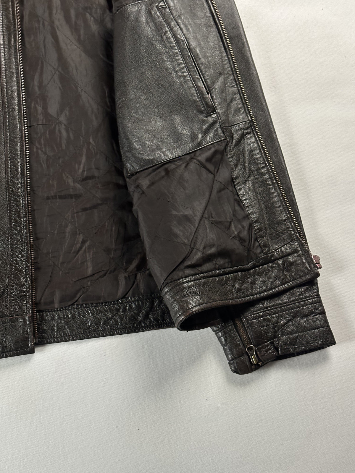Sleeve folded back over the brown lining with the cuff zip open
