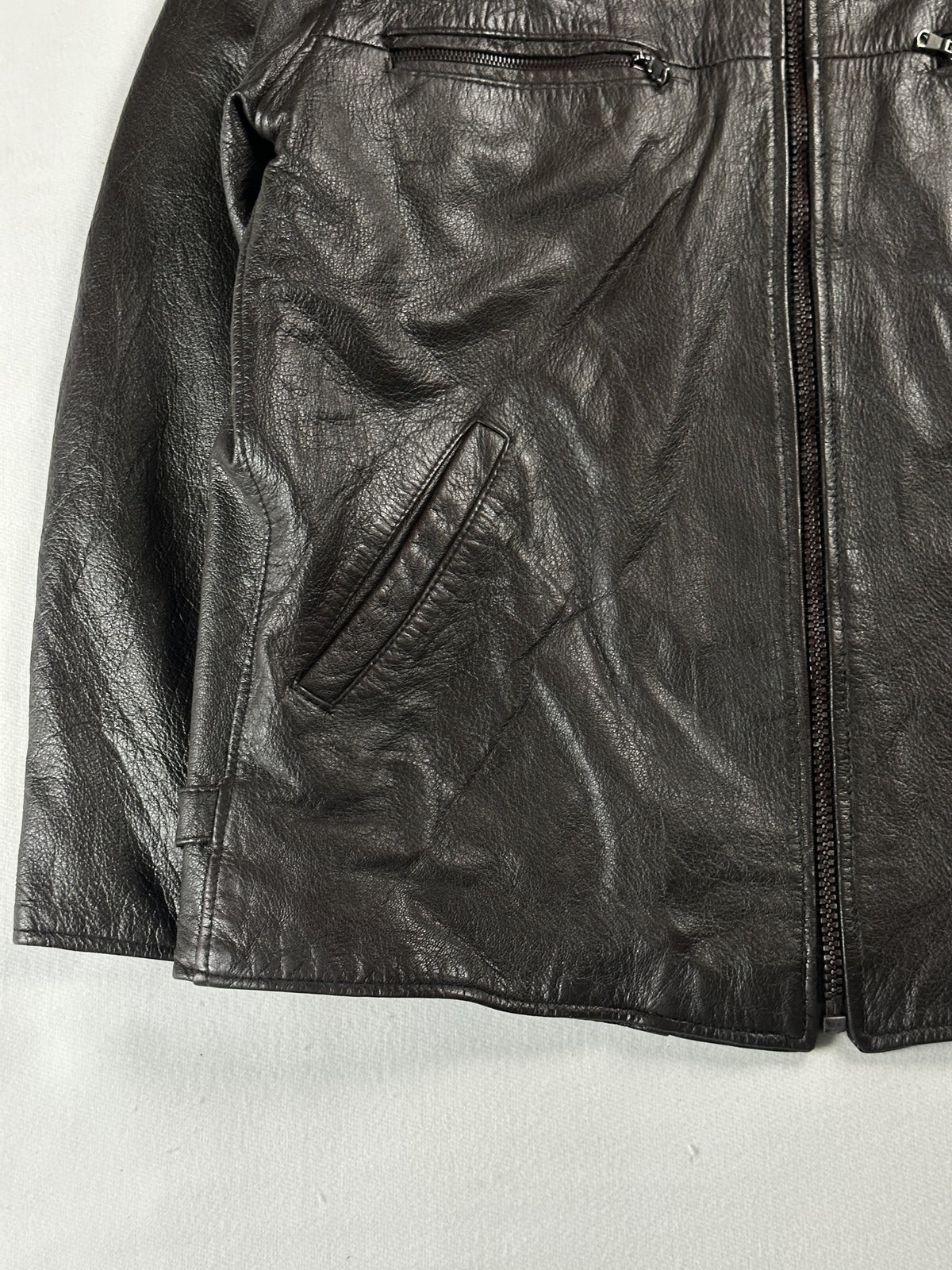 Angled hand pocket beside the front zip on the left side of the brown leather