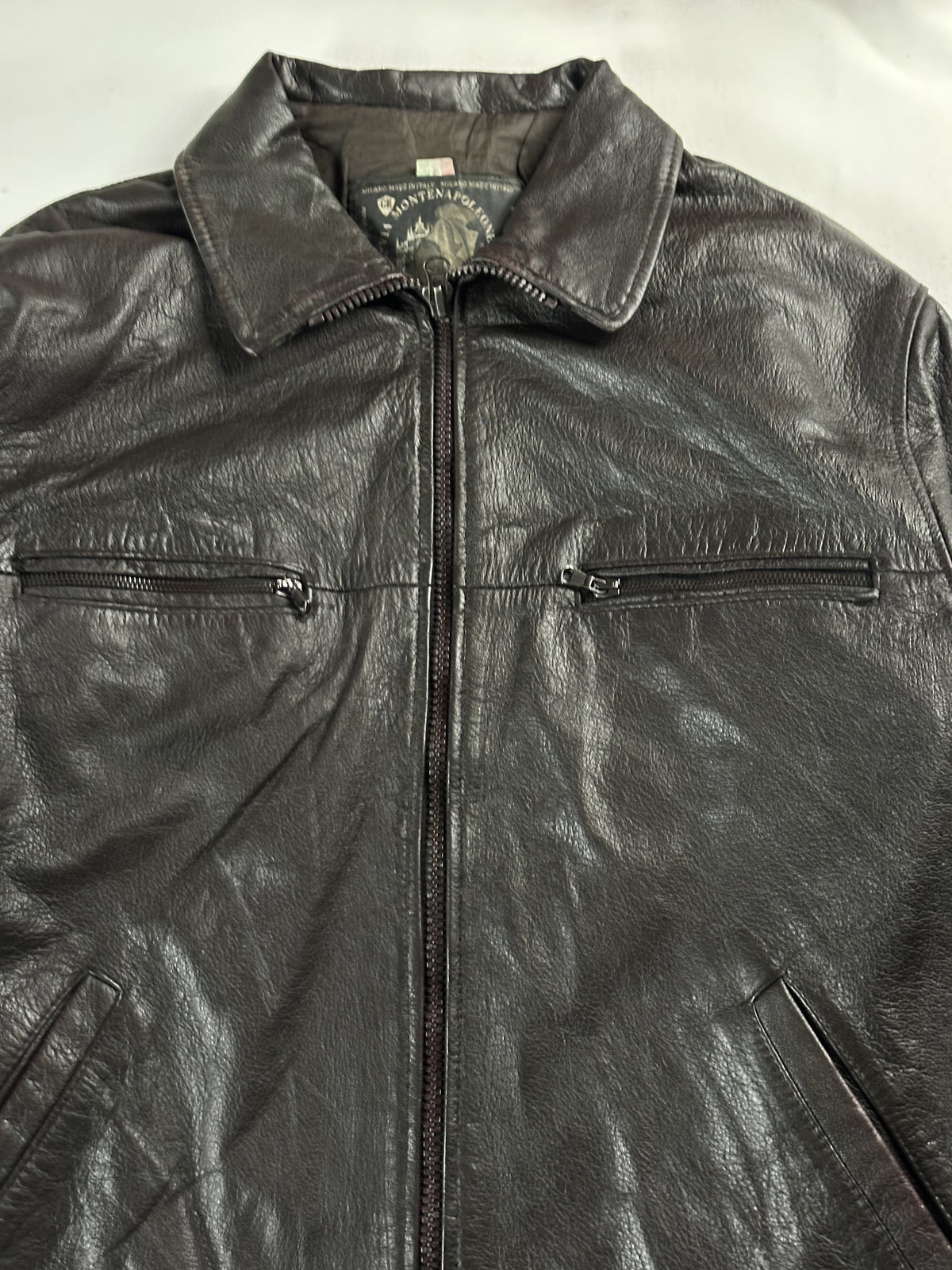 Close view of the collar and the pair of horizontal chest zip pockets