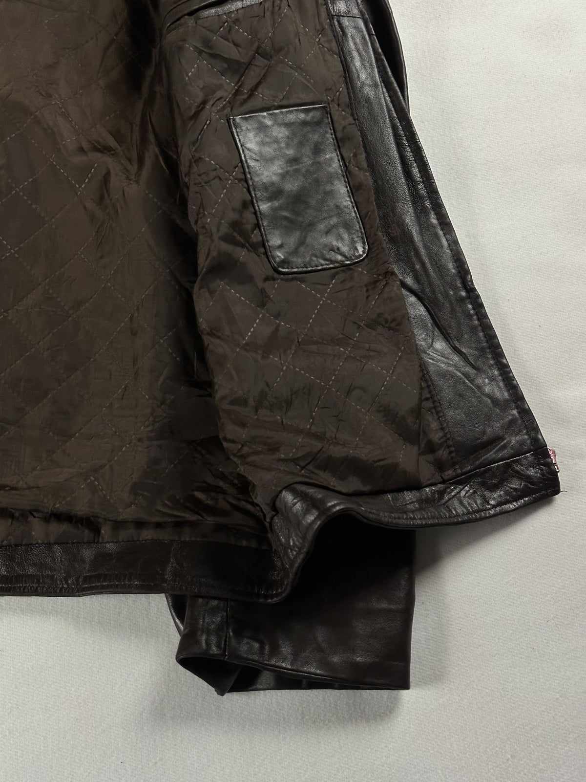 Quilted brown lining inside the jacket with a leather-trimmed inner pocket