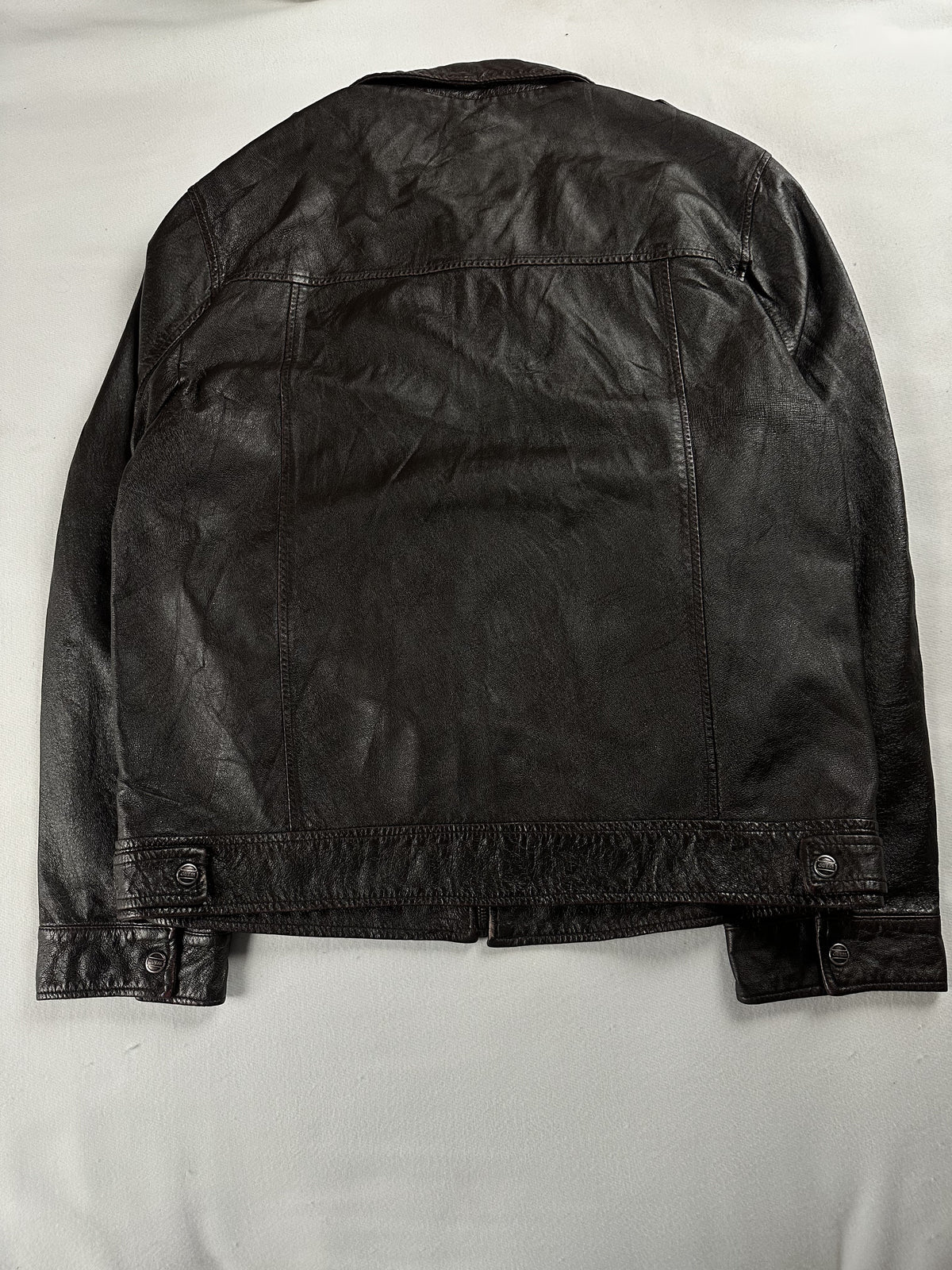 Rear view of the size L brown jacket laid flat, showing studded waist tabs at the hem