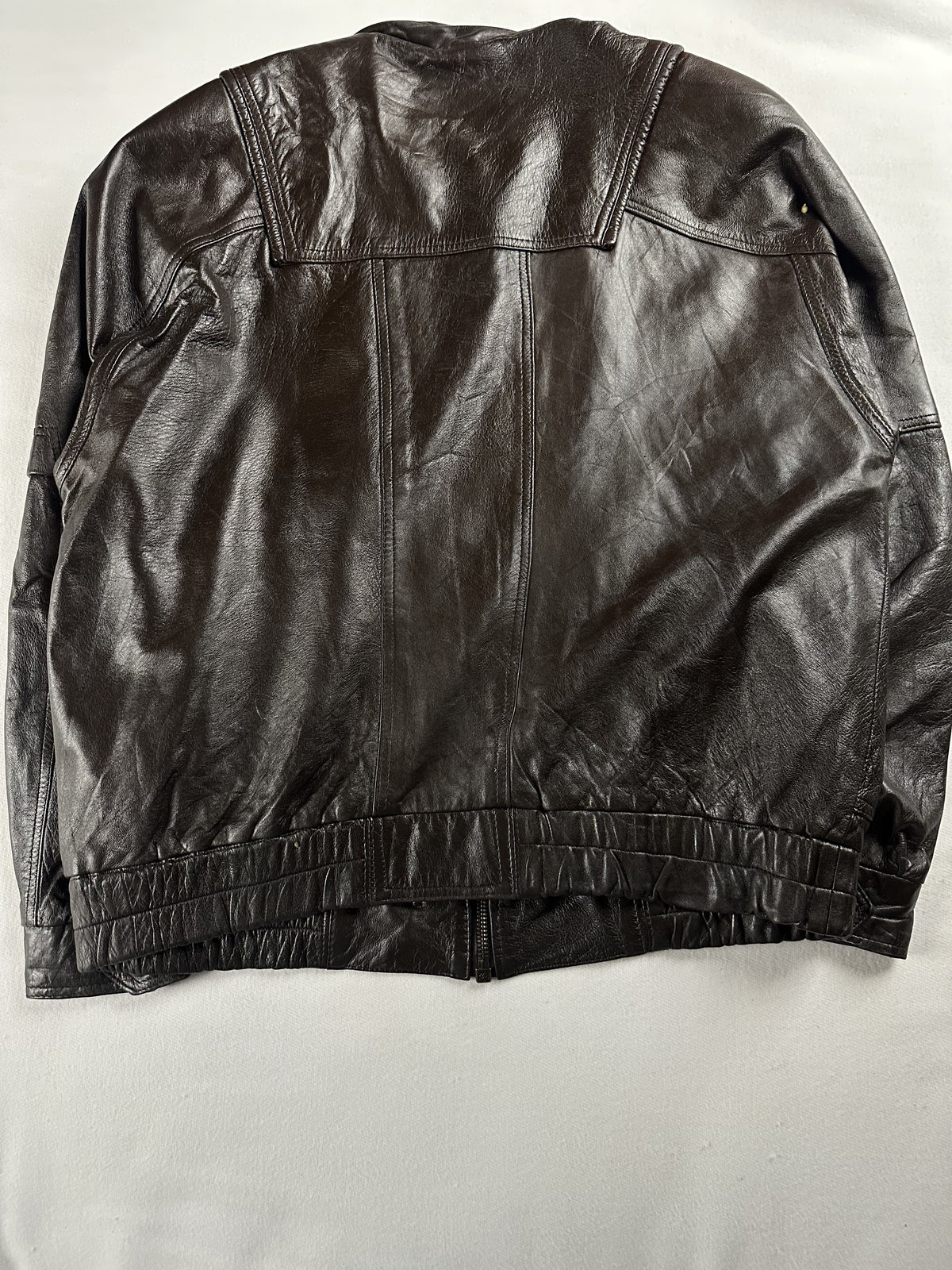 Pockets set across the front of the brown leather field jacket