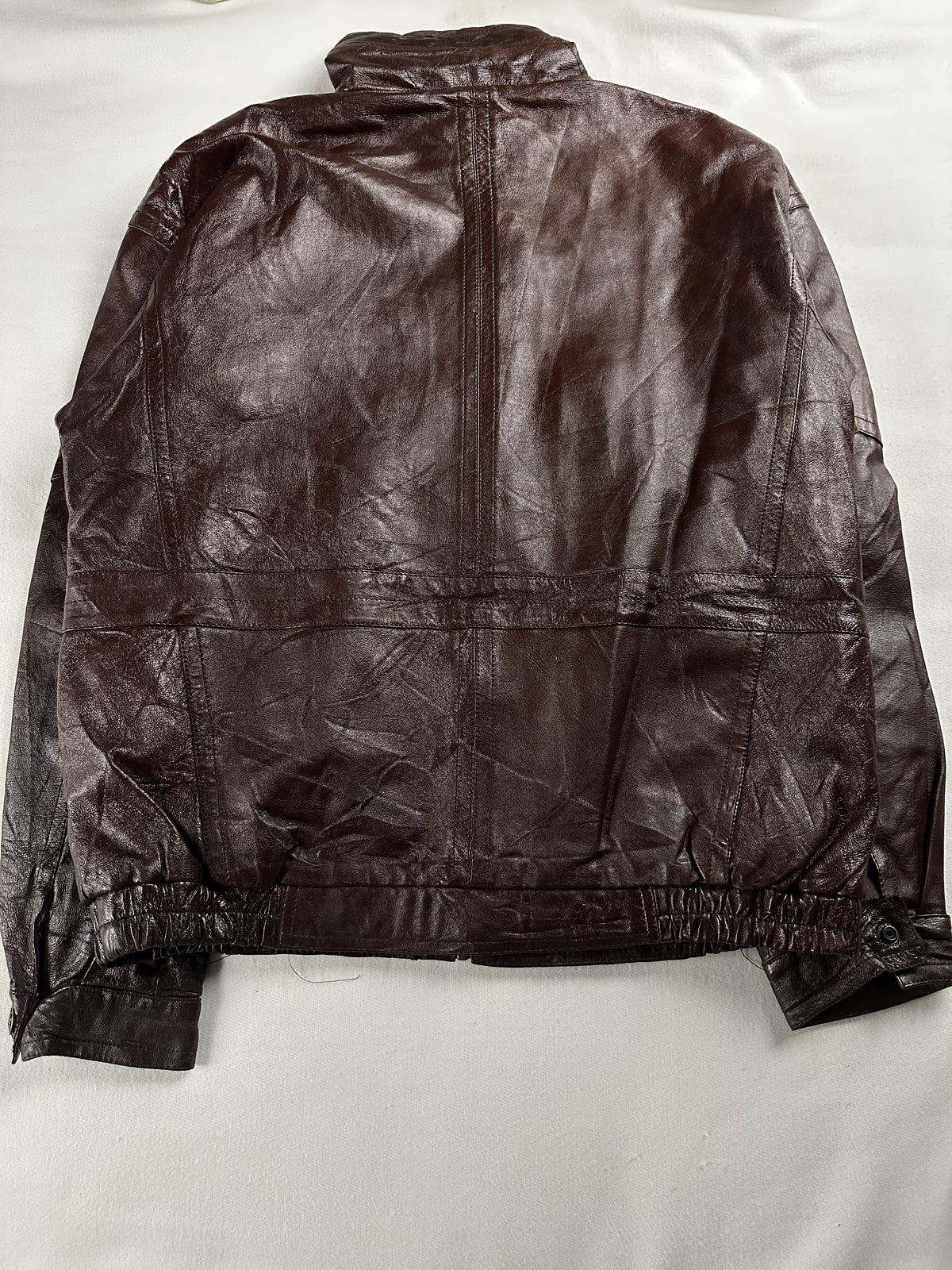 Rear view of the roomy XL brown jacket with its elasticated waistband and buttoned side tabs