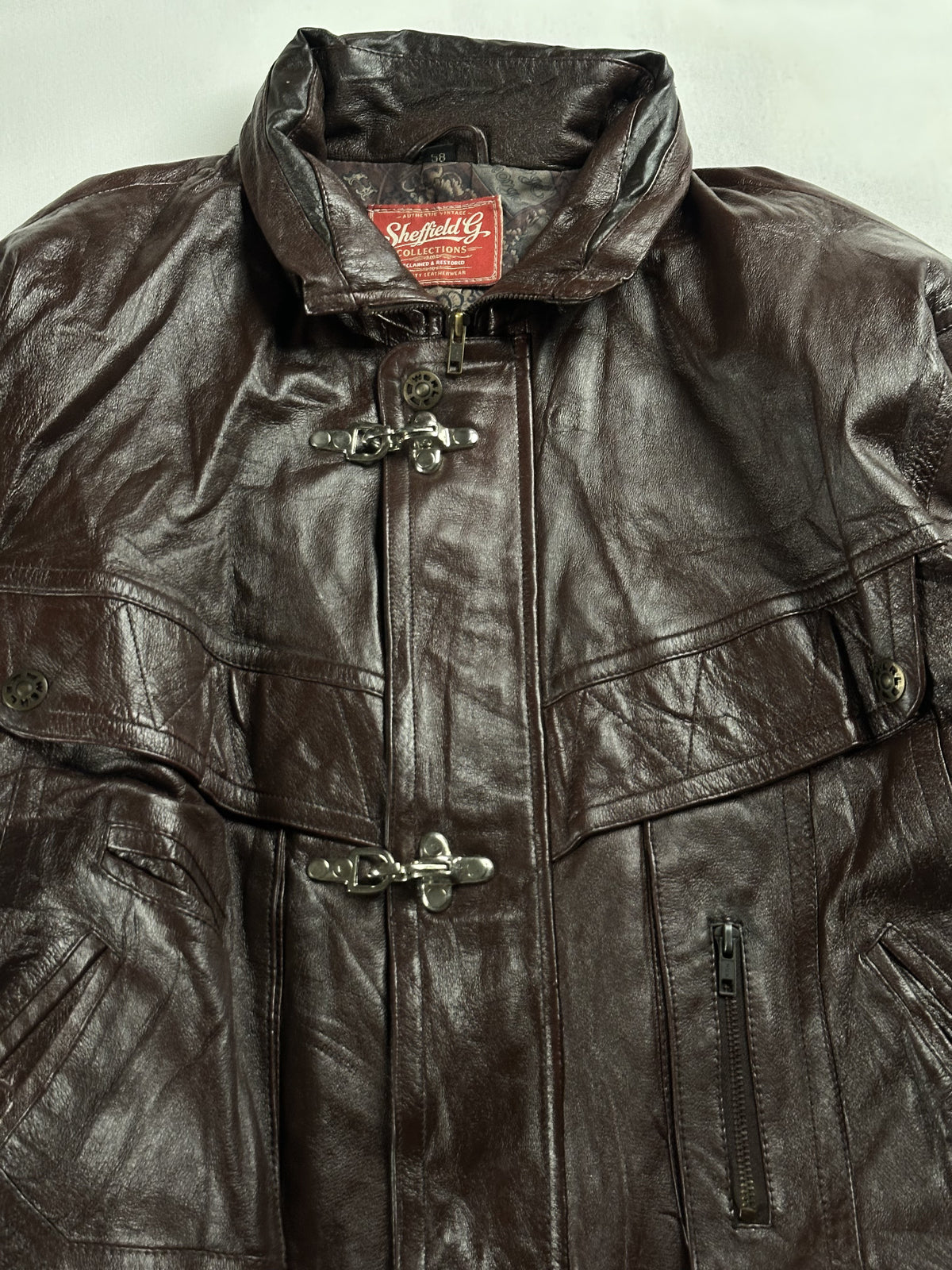 Close view of the stand collar and the metal hook clasps fastening the front