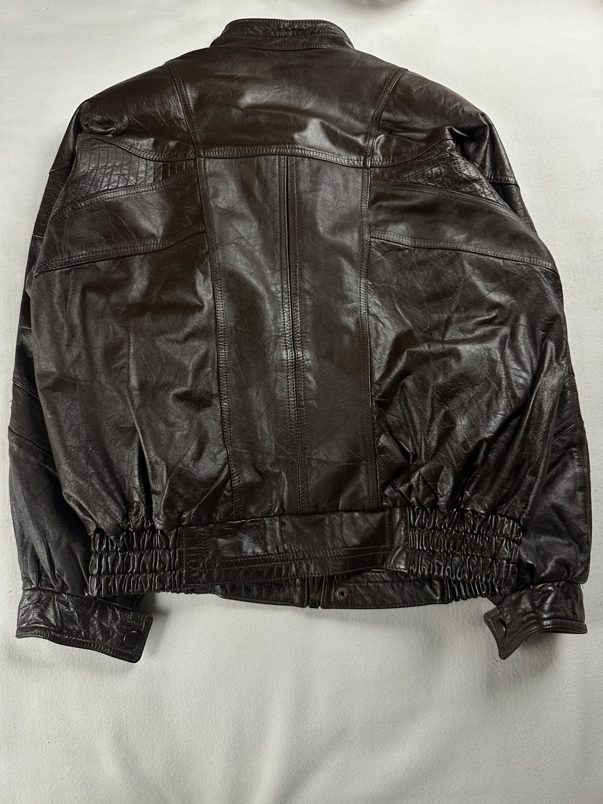 Back of the XXL brown blouson laid flat with its elasticated waistband