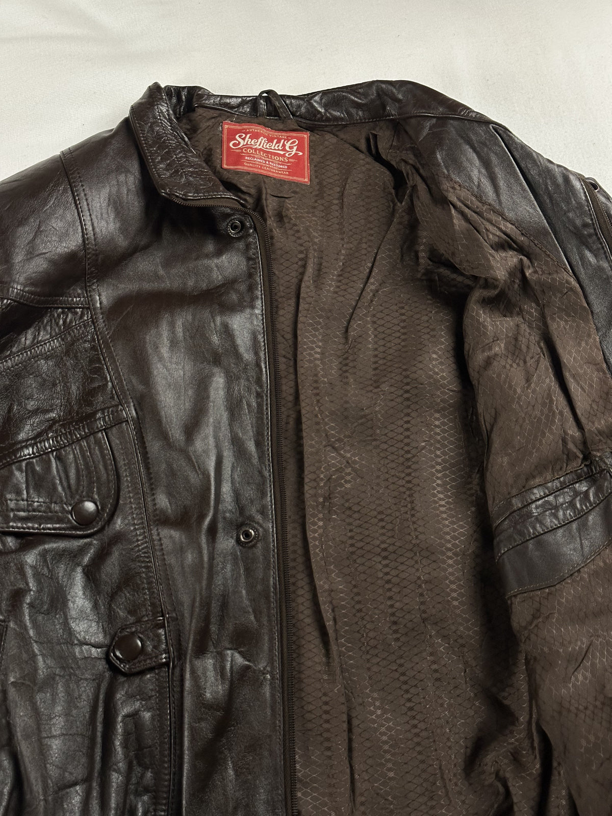 Brown lining inside the roomy blouson, held open to show the interior