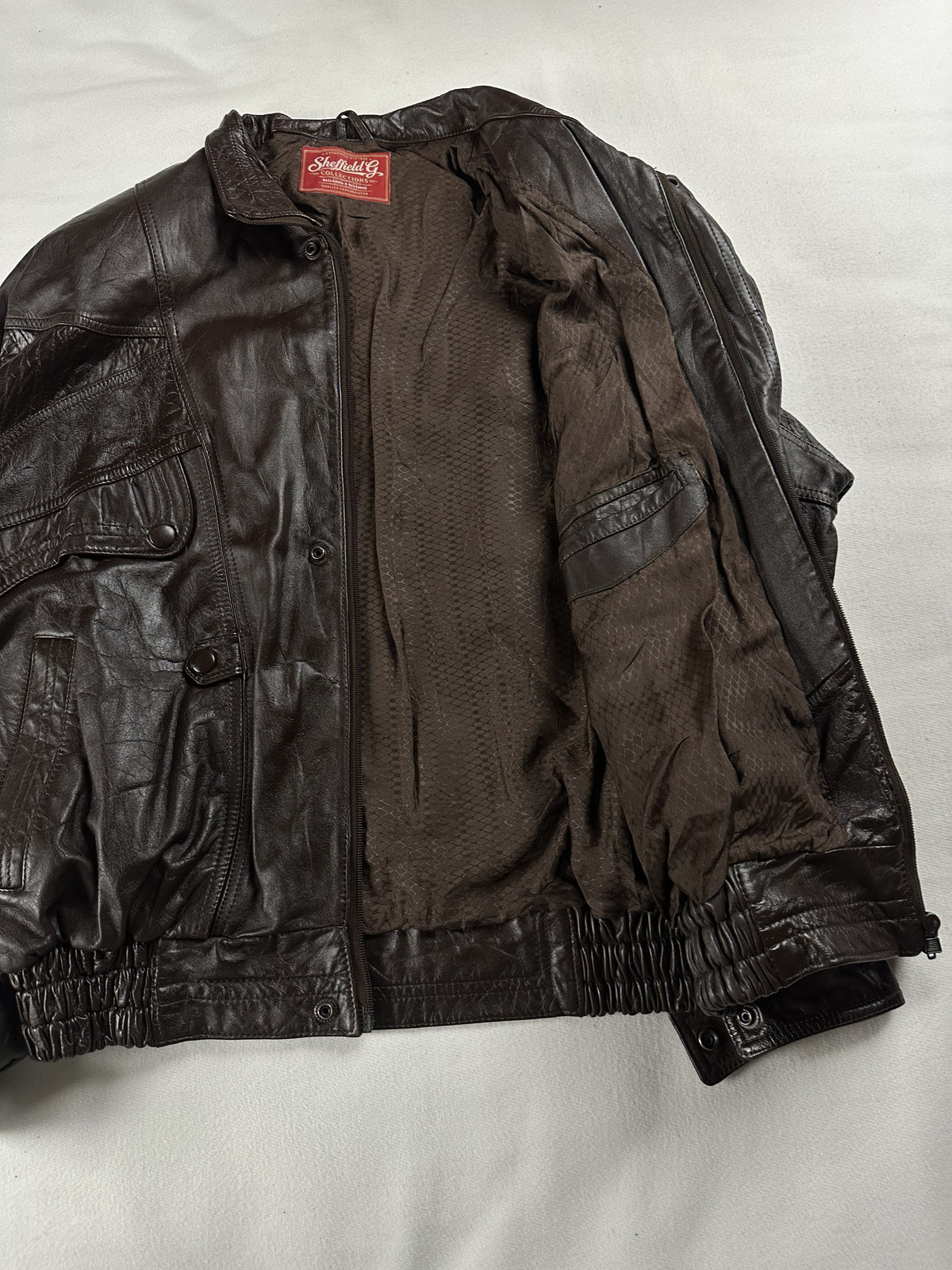 Angled view of the jacket opened out across the lining and sleeve