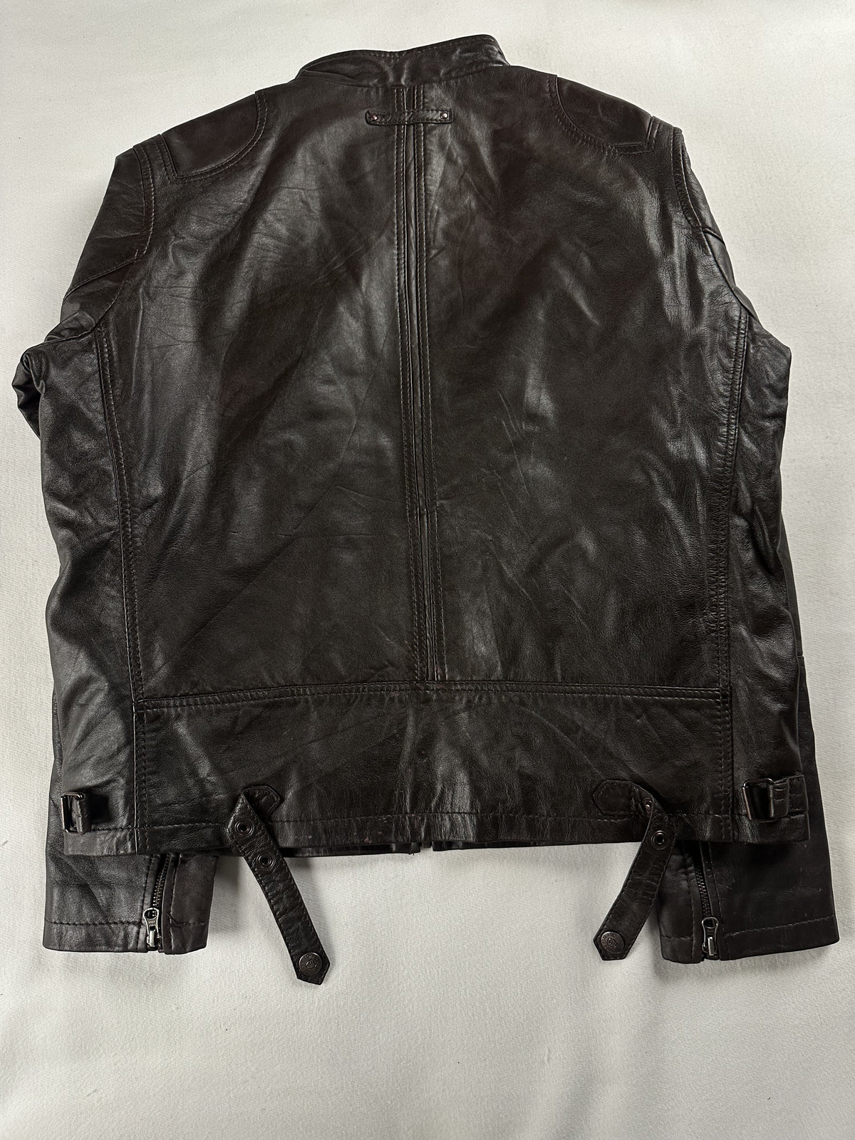 Back of the size L cafe racer laid flat with side waist straps and a centre seam