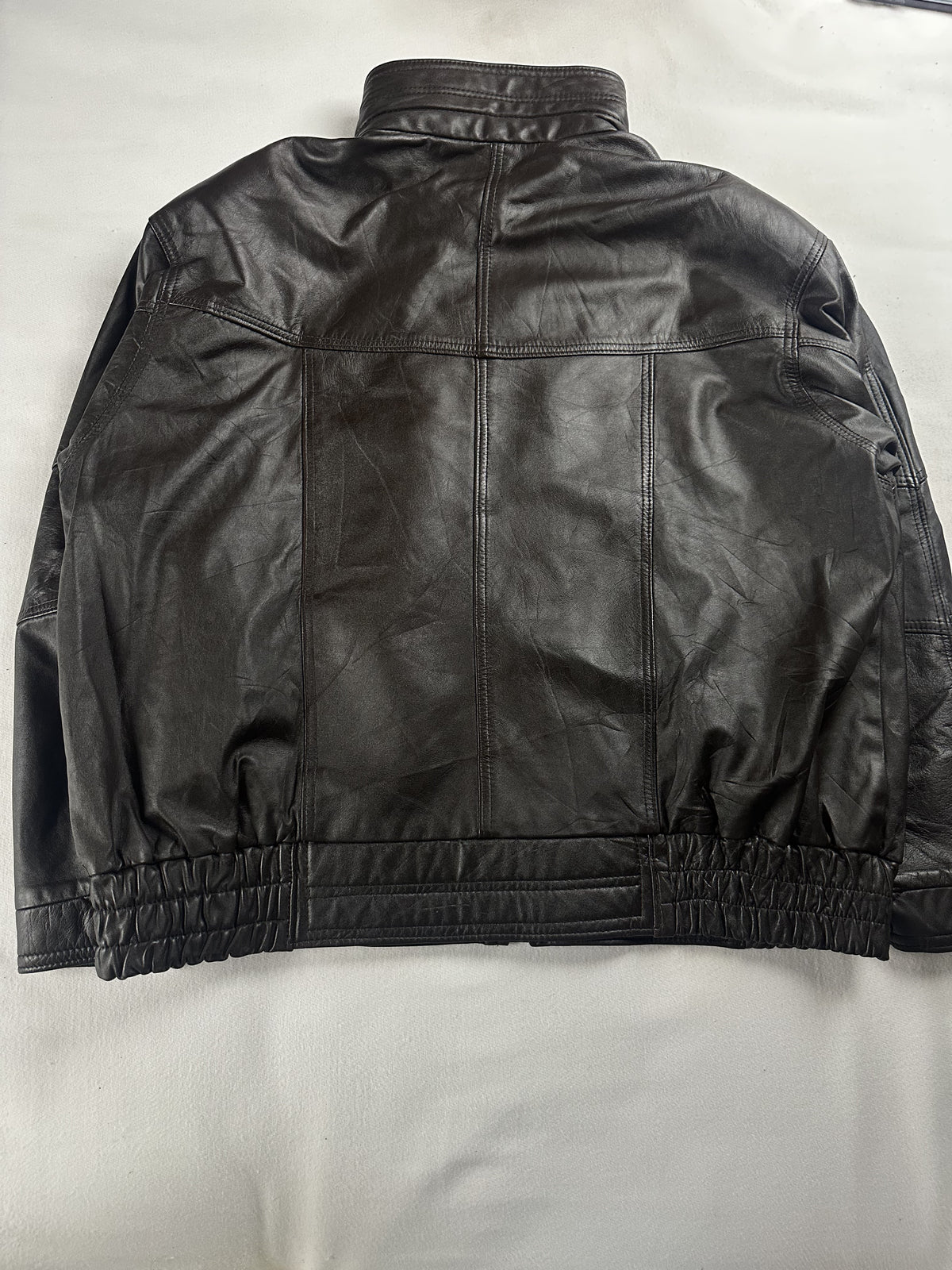 Quilting across the shoulder of the brown leather jacket