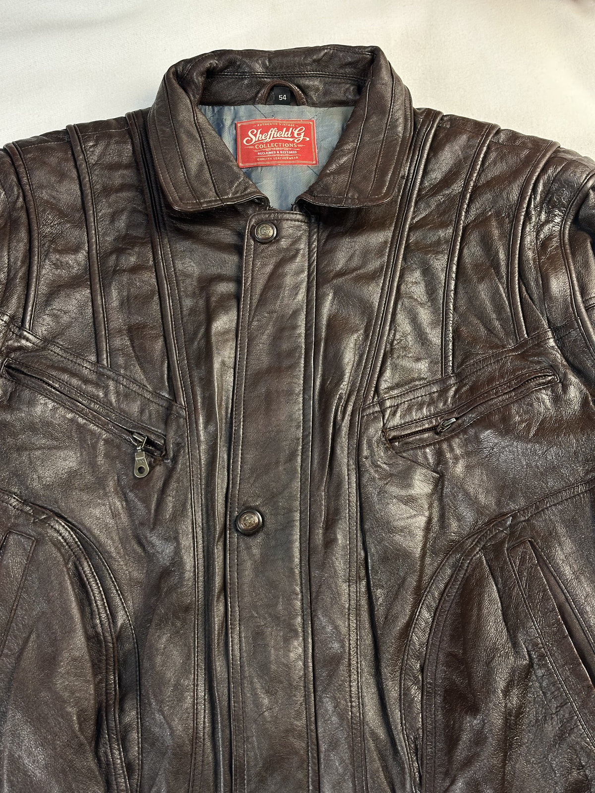 The size XL brown harrington, 27 inches long through the body