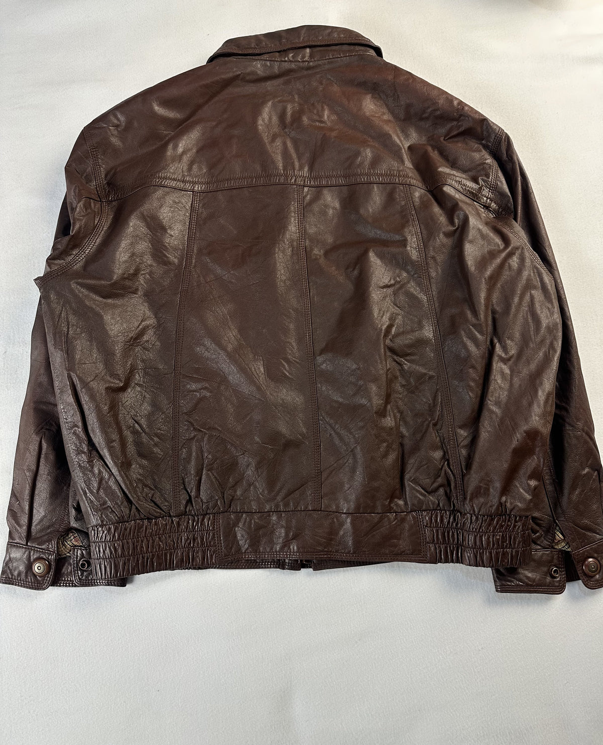 Tartan lining inside the brown leather harrington
