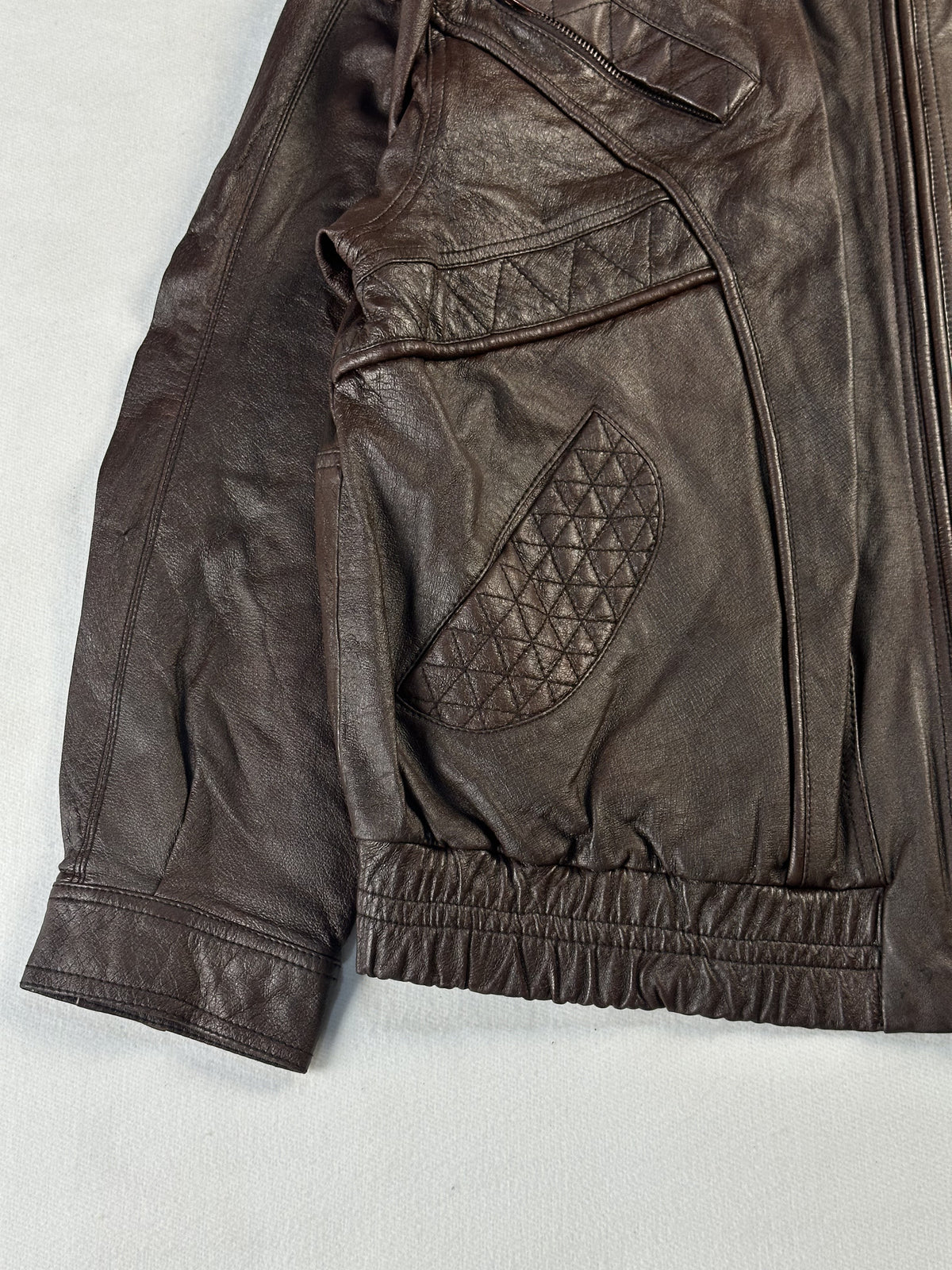 Diamond quilted pocket panel on the left front, above the gathered elastic waist