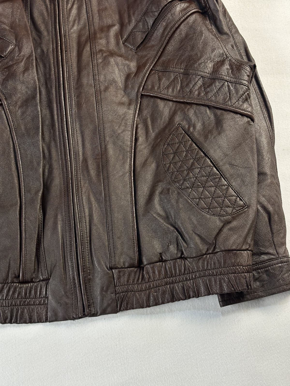 Right hand quilted pocket beside the centre zip, with the elasticated waist below
