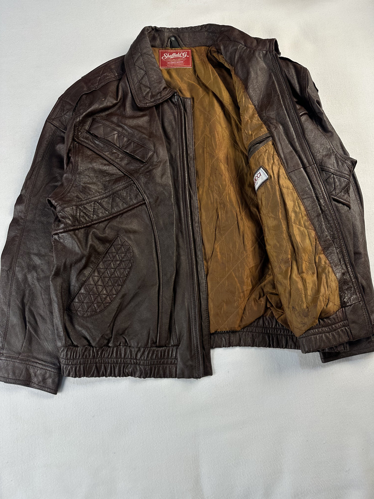 Brown Harrington held open to show the full tan quilted lining