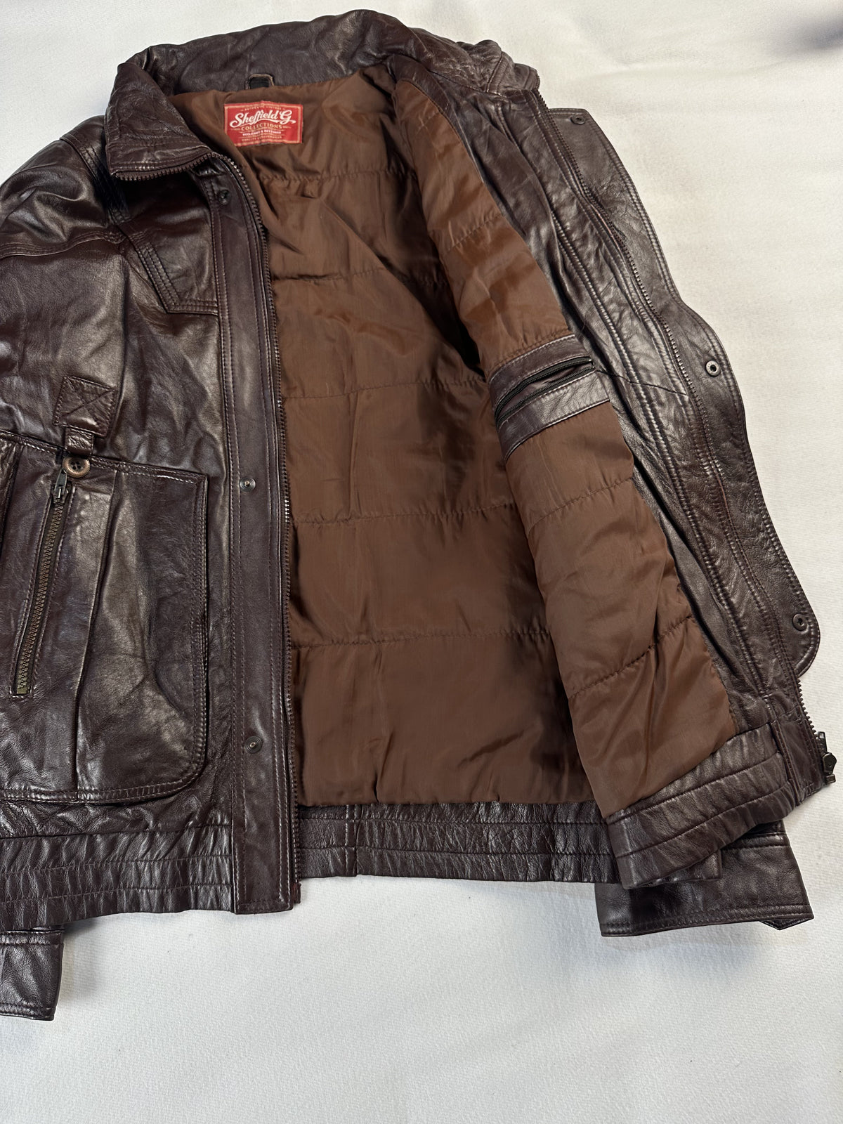 Broad shouldered brown leather field jacket in size XL, 24 inches across