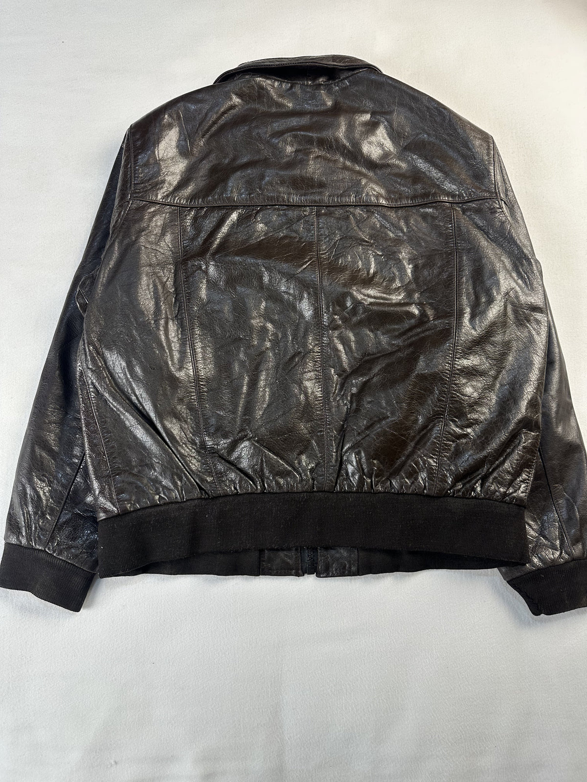 Rear view of the slim size L brown flight jacket showing the rib hem across the back