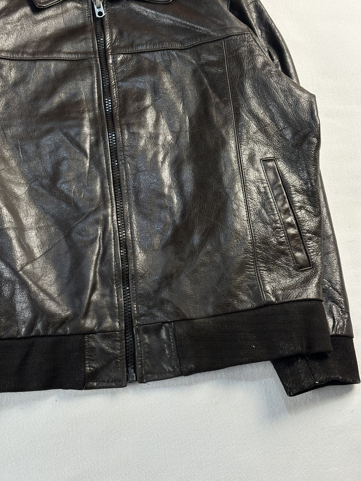 Open centre zip and the right hand welt pocket over the knitted rib hem