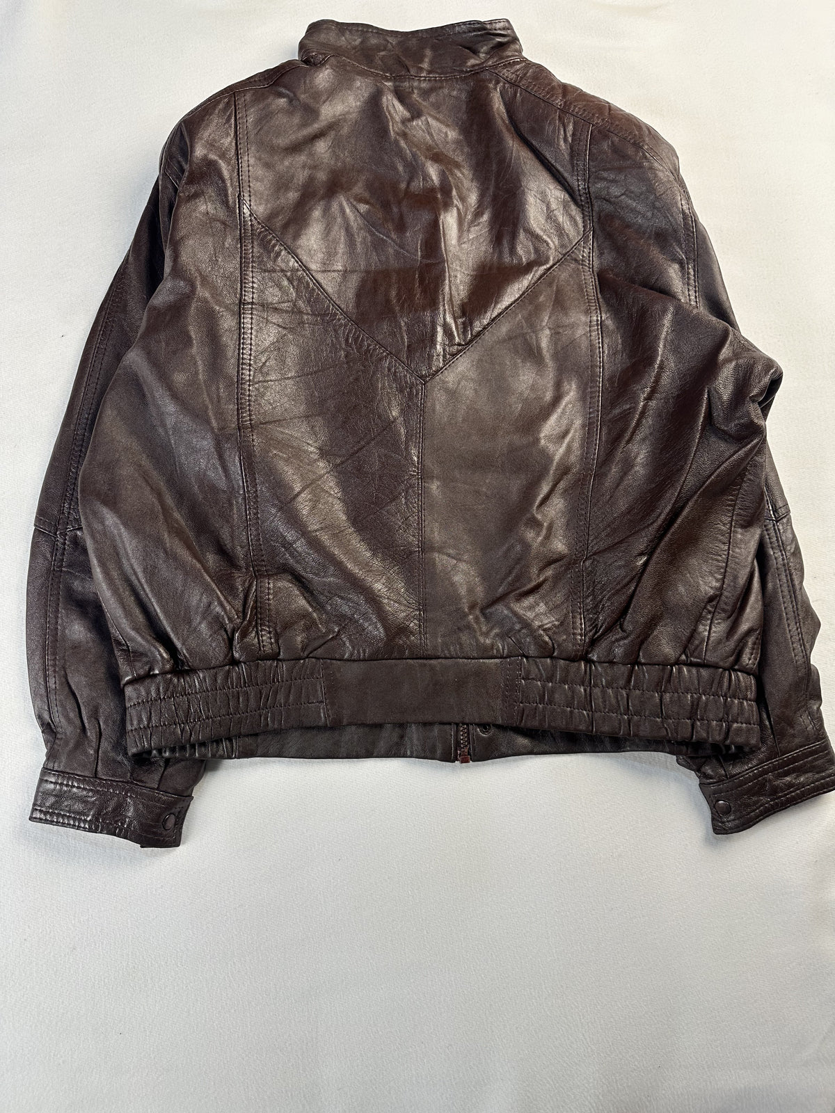 Rear view of the blouson cut XXL brown jacket with its chevron yoke and elasticated waist