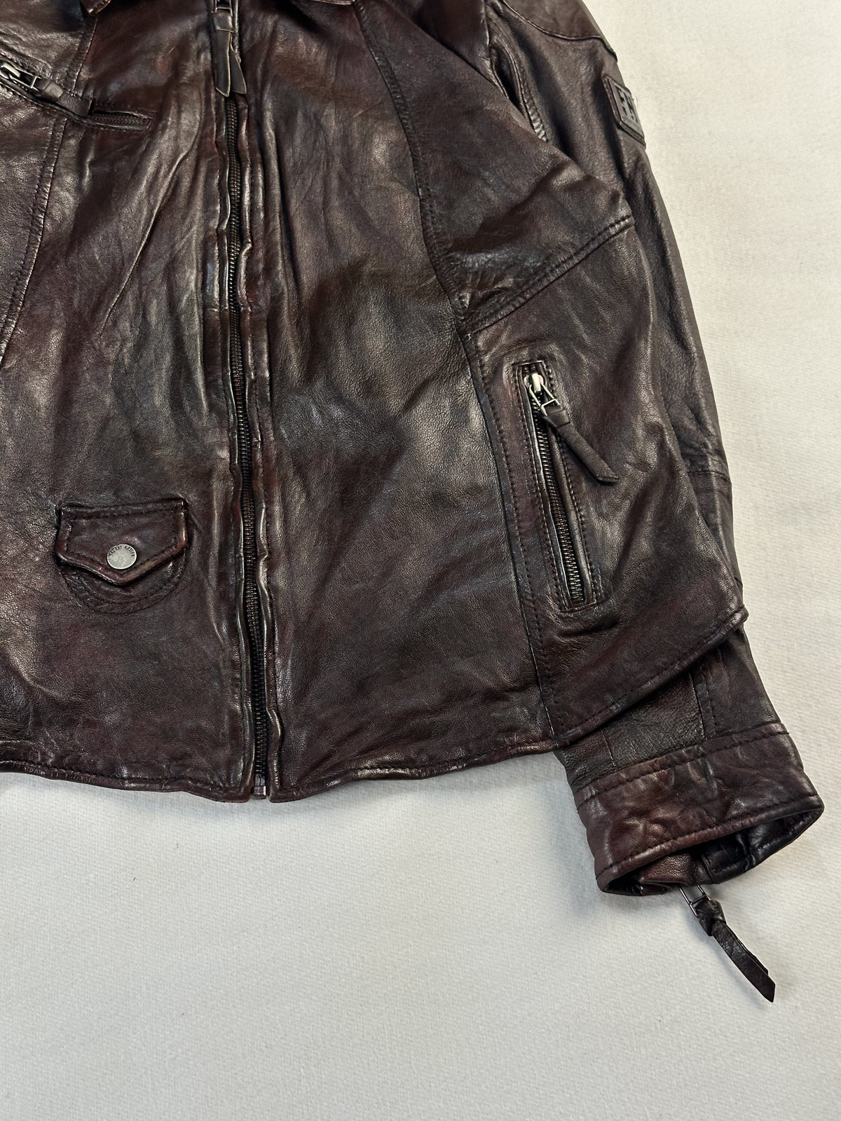 Right front of the jacket showing a slim zip pocket, flap pocket and turned cuff