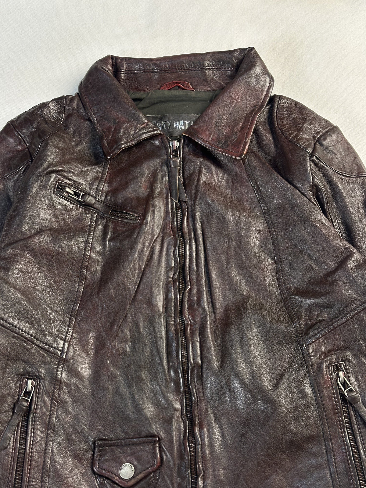 Close view of the collar and the two vertical chest zips flanking the front opening