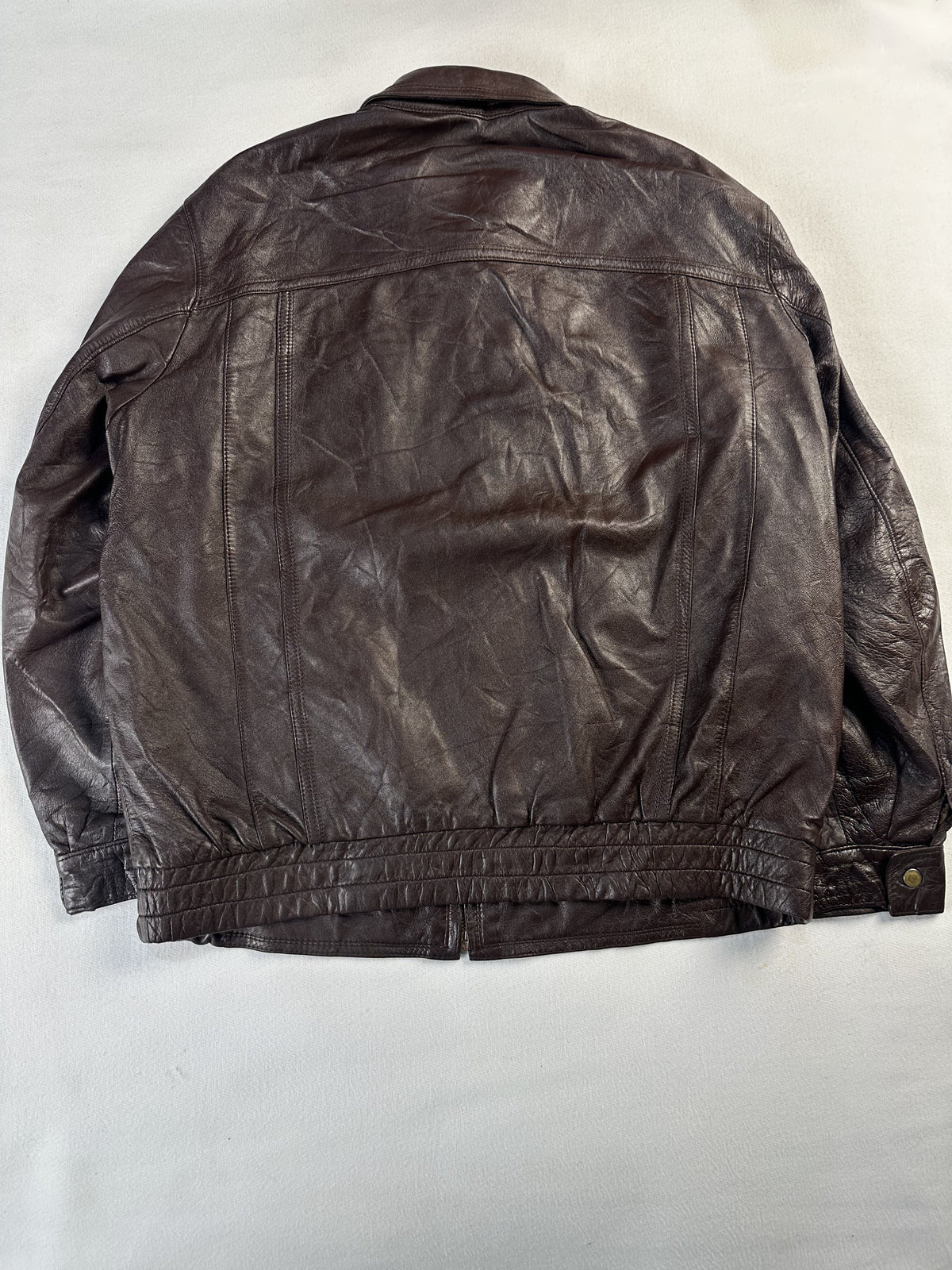 Tan lining inside the brown leather harrington