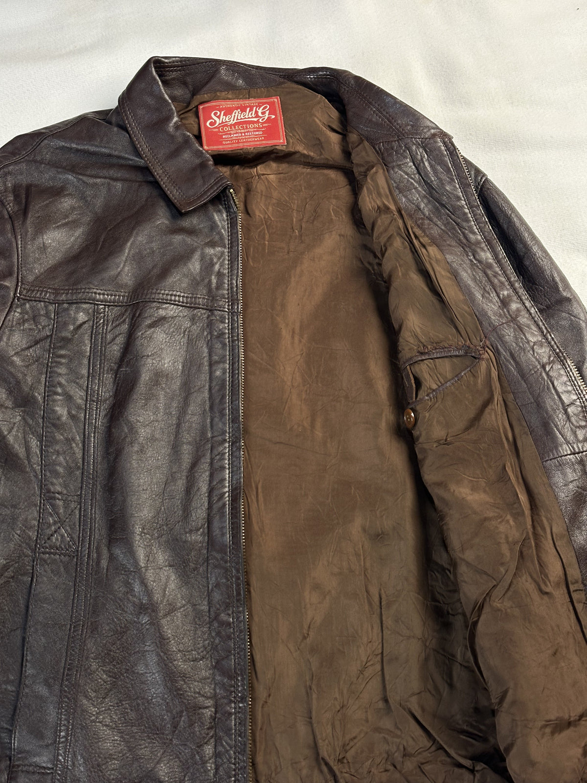 Brown real leather harrington with a 22 inch sleeve, size L