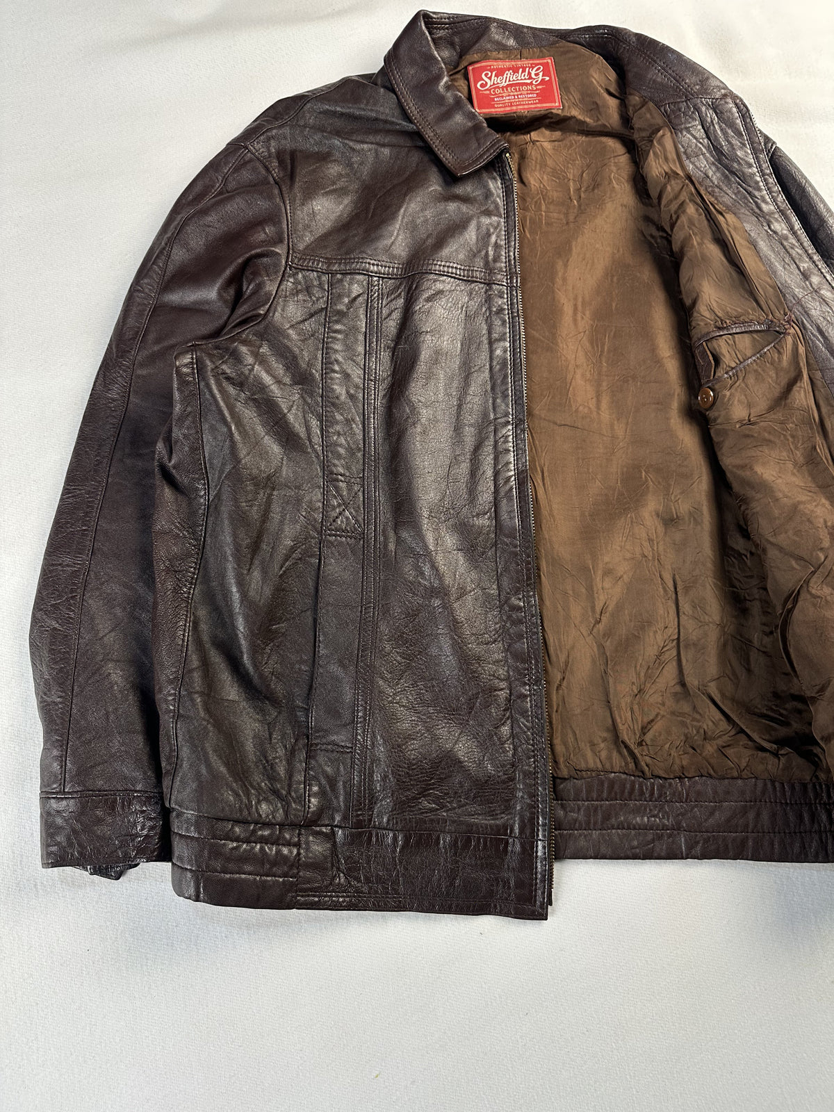 Slim shouldered brown leather harrington jacket in size L