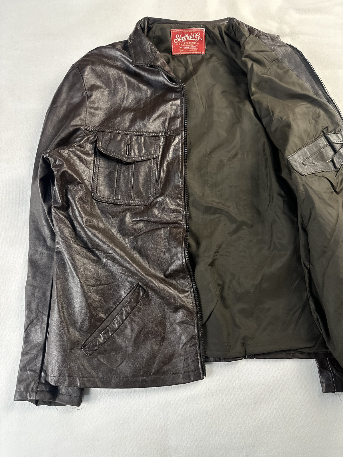 Narrow shouldered brown leather field jacket in size L