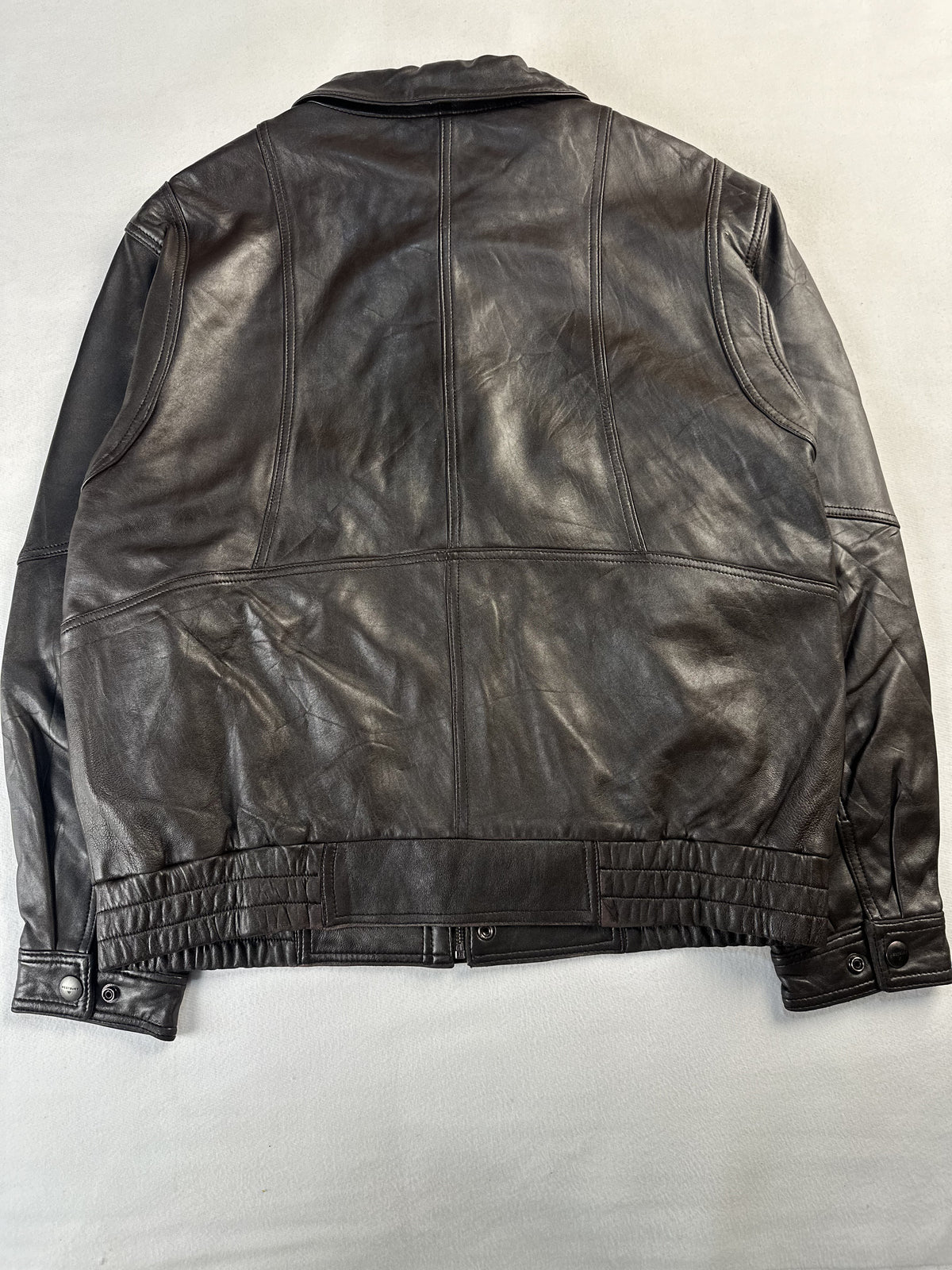 Quilted waistband running along the hem of the brown cafe racer