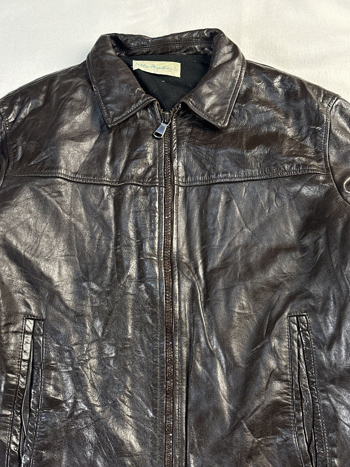 Close view of the shirt collar and neck label at the top of the jacket