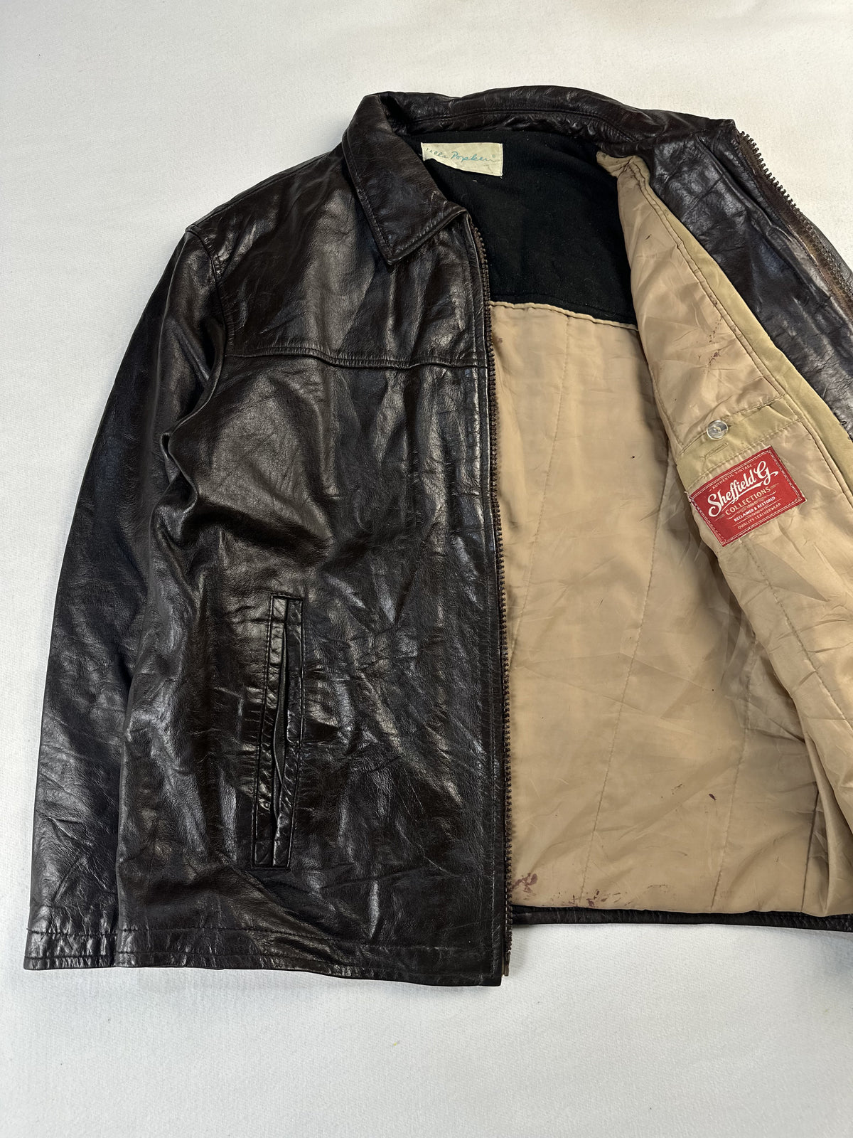 Jacket held open to reveal the full tan cotton lining and inner pocket