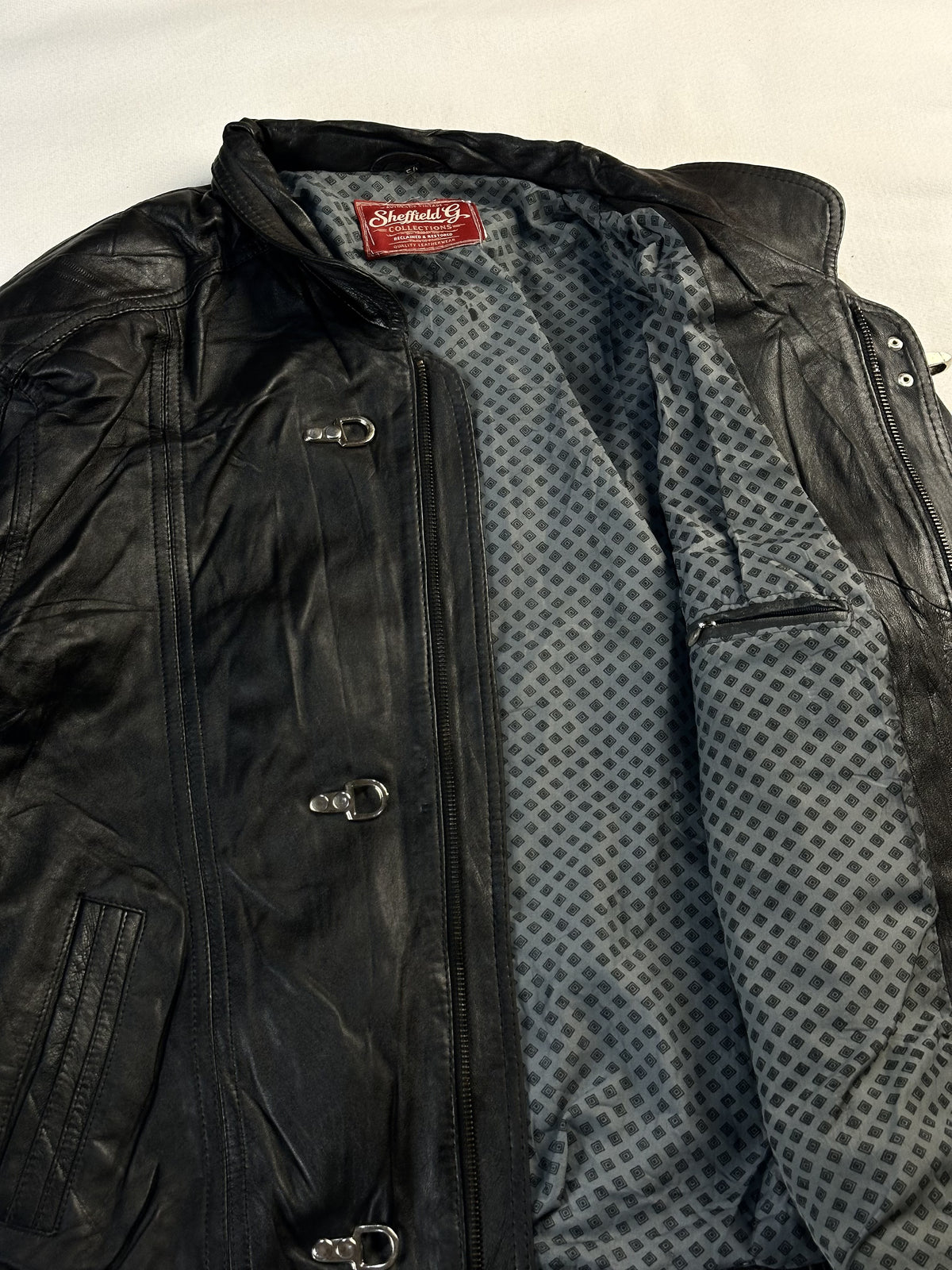 Black leather vintage jacket, size L - cuff and hem detail.
