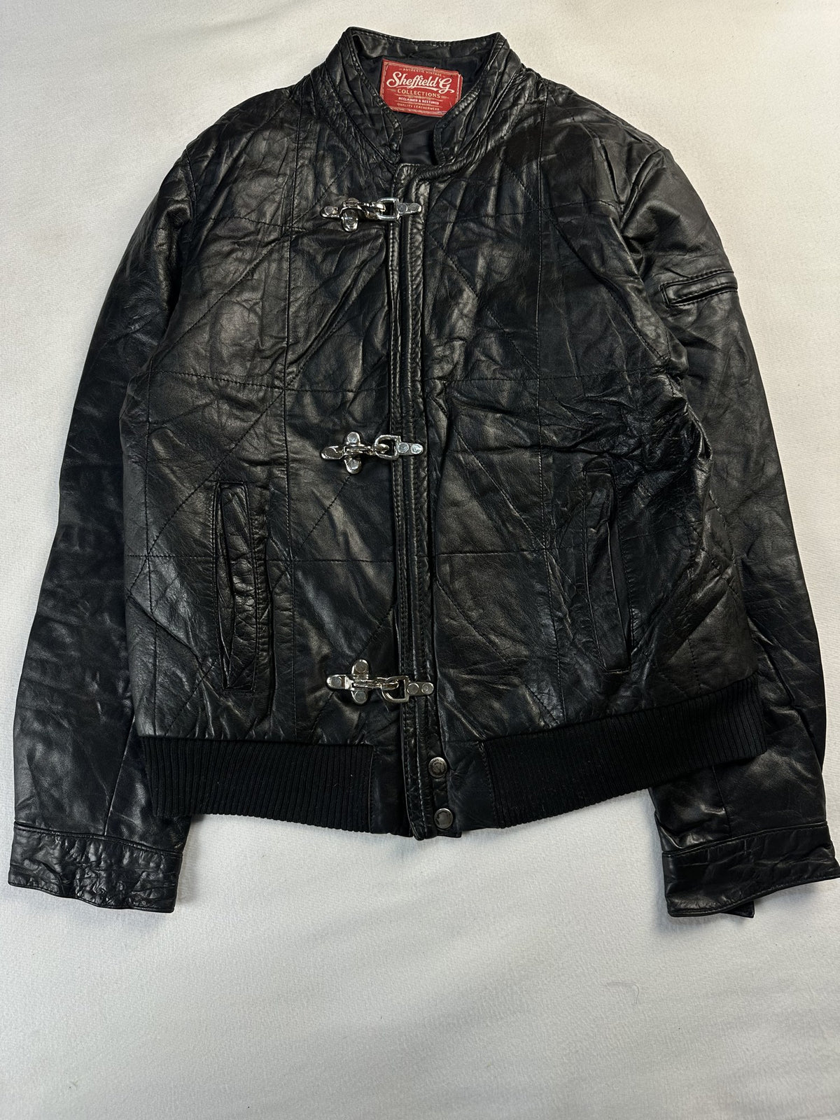 Black leather bomber jacket, size S - chest and pocket detail.