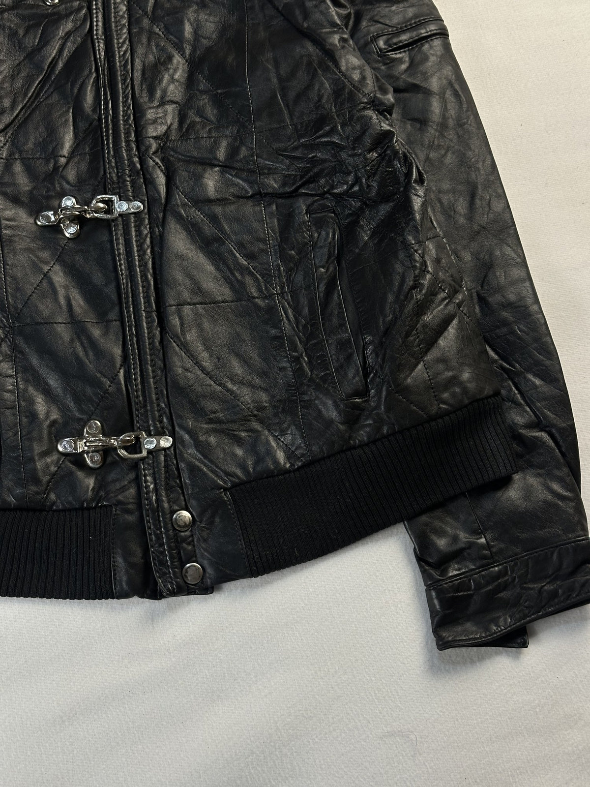 Black leather bomber jacket, size S - size and label context.
